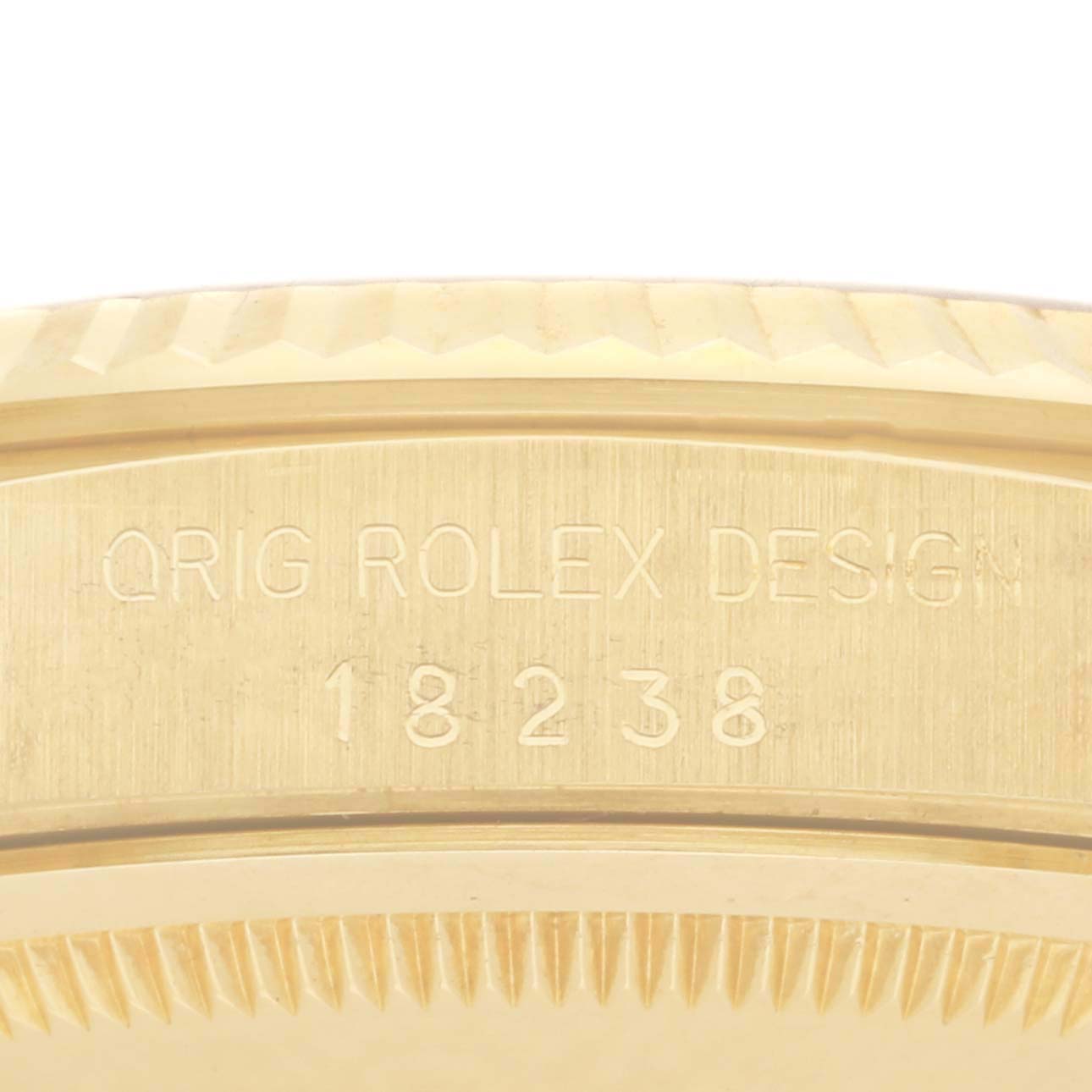 The image shows a close-up of the edge and serial number of a Rolex President 18238 Men's Yellow Gold Black Dial 18238 Men's Yellow Gold Black Dial model.