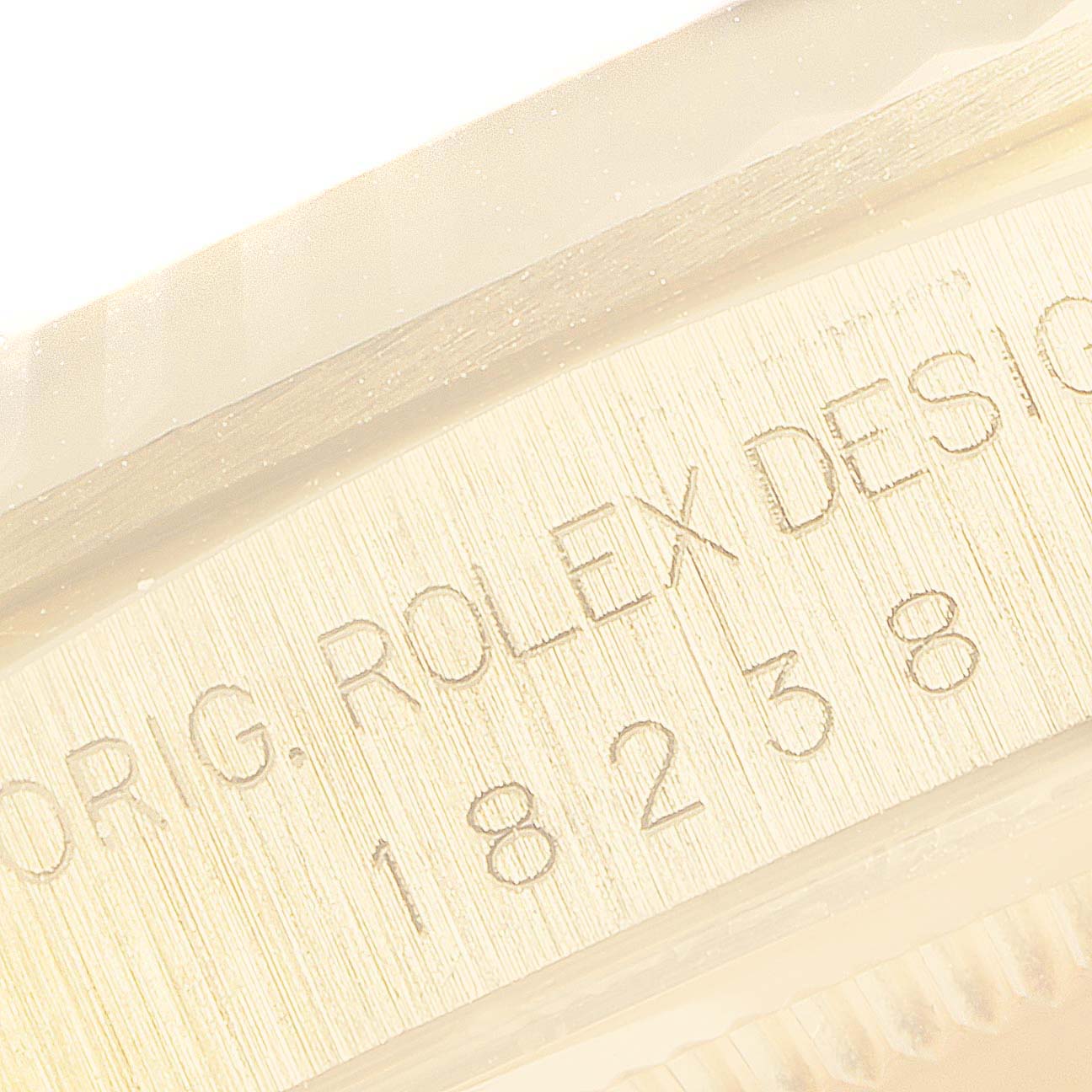 This image shows a close-up of the side and edge of the case of a Rolex President 18238 Men
s Yellow Gold Champagne Dial 18238 Men
s Yellow Gold Champagne Dial model watch, highlighting the engraved text and model number.