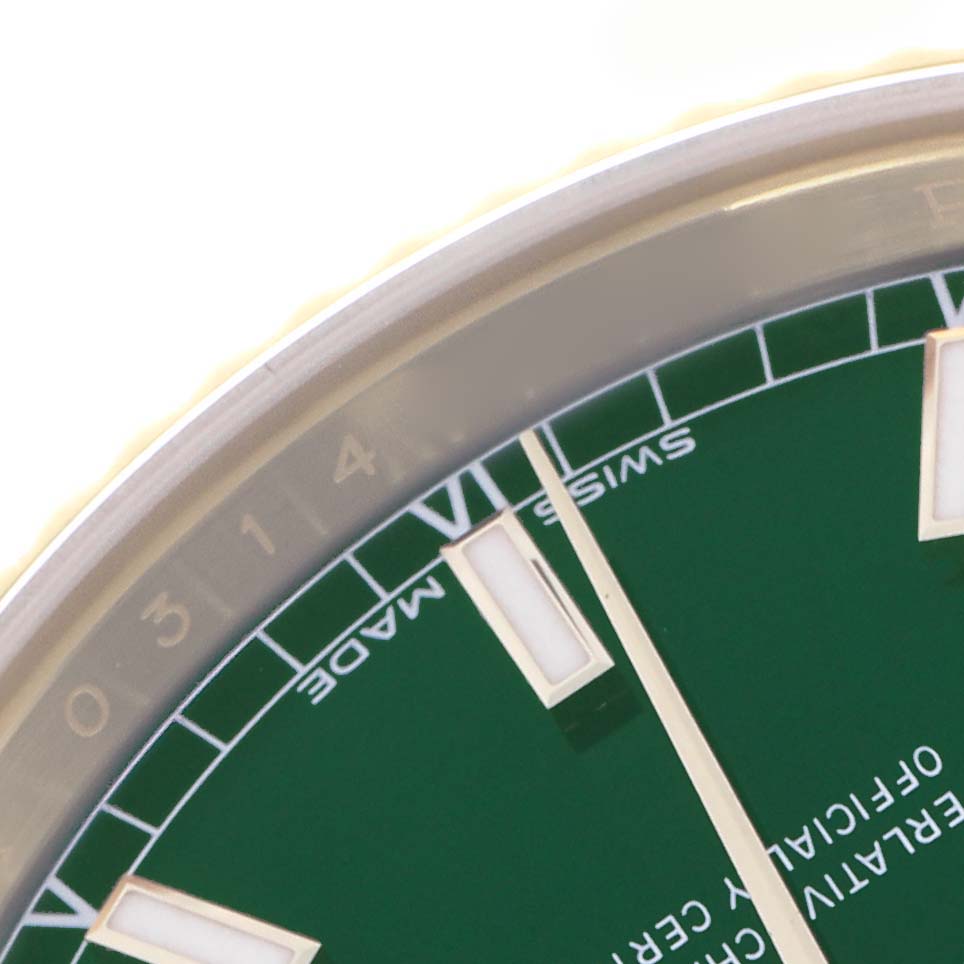 The image shows a close-up of the bezel and dial of a Rolex President 118138 Men's Yellow Gold Green Dial model at an angle, highlighting the markers and "SWISS MADE" text.