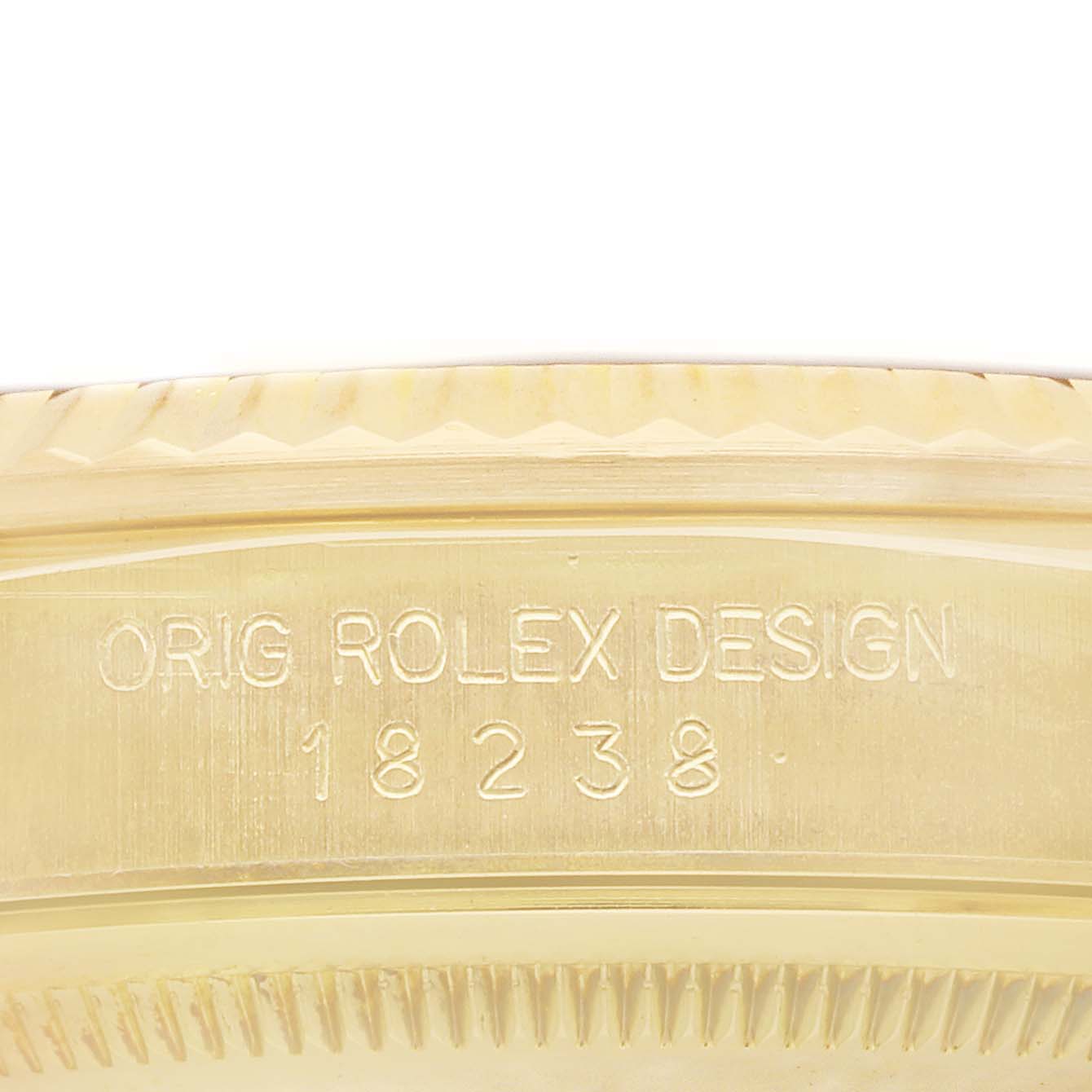 The image shows a close-up of the side of a Rolex President 18238 Men's Yellow Gold Champagne Dial model where the case engraving "ORIG ROLEX DESIGN" and model number "18238" are visible.
