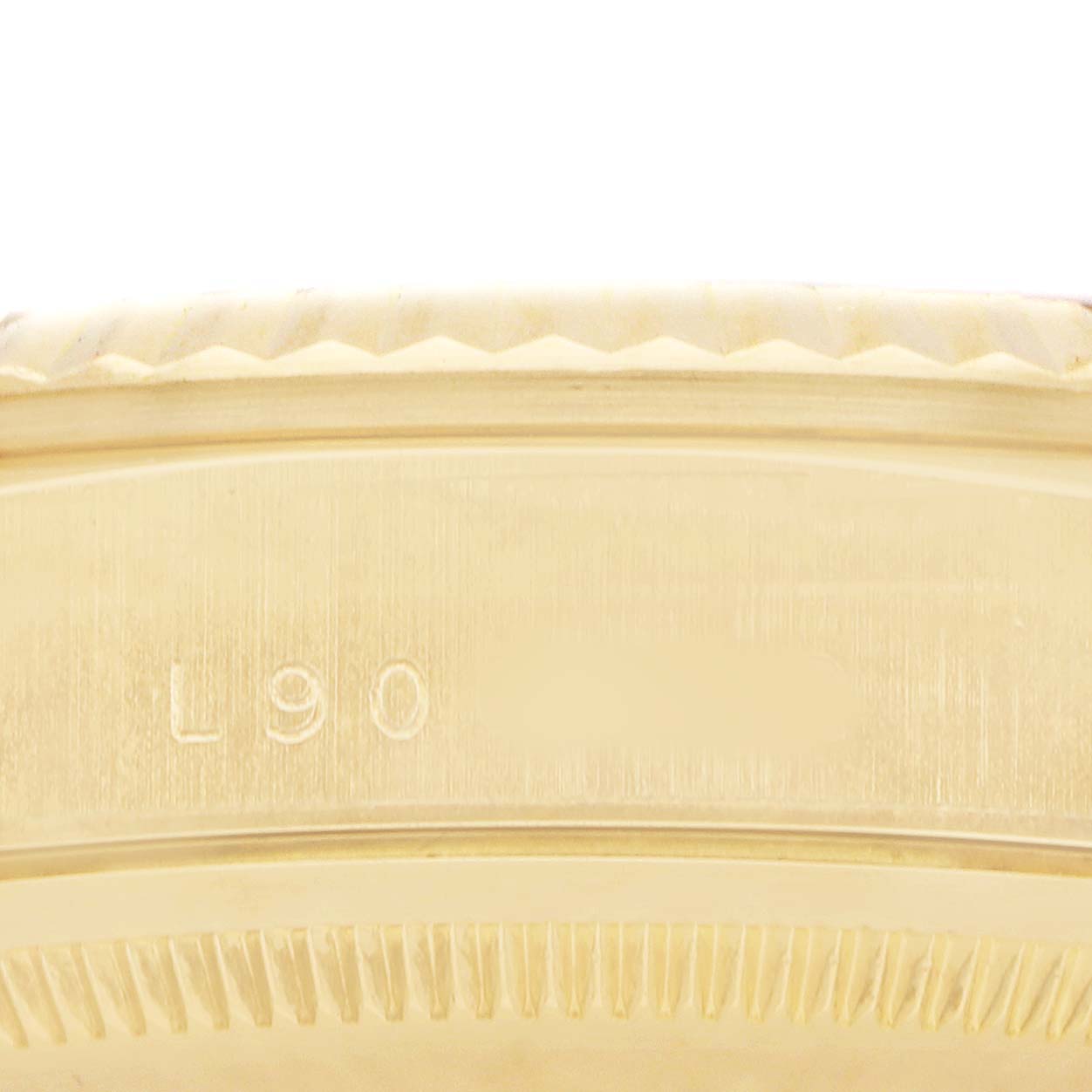 The image shows a close-up of the bezel and case edge of the Rolex President 18238 Men's Yellow Gold Champagne Dial model, highlighting its engraving details.