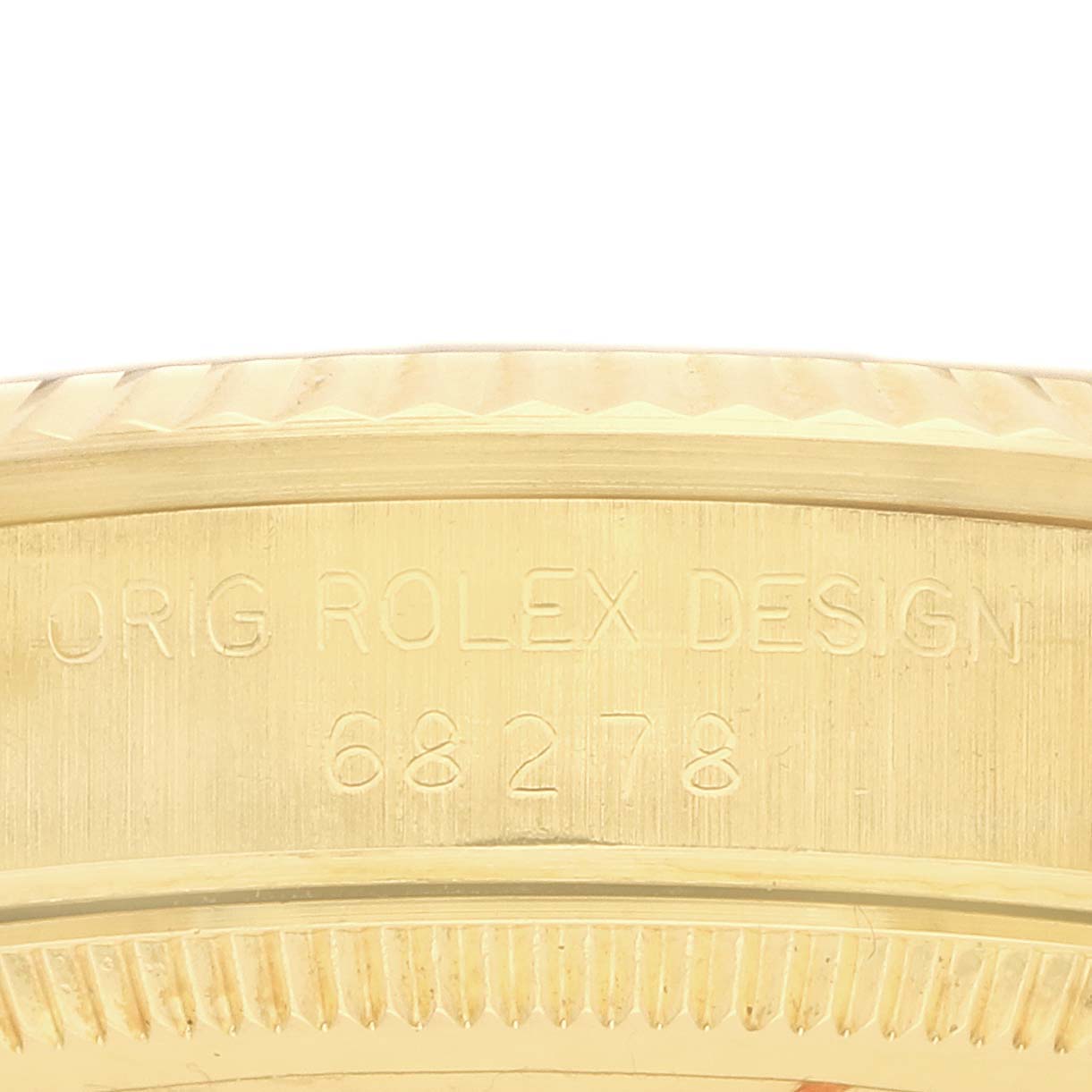 The image shows a close-up of the side of a Rolex Mid-Size 68278 Women's Yellow Gold White Dial watch, focusing on the engraved model details.