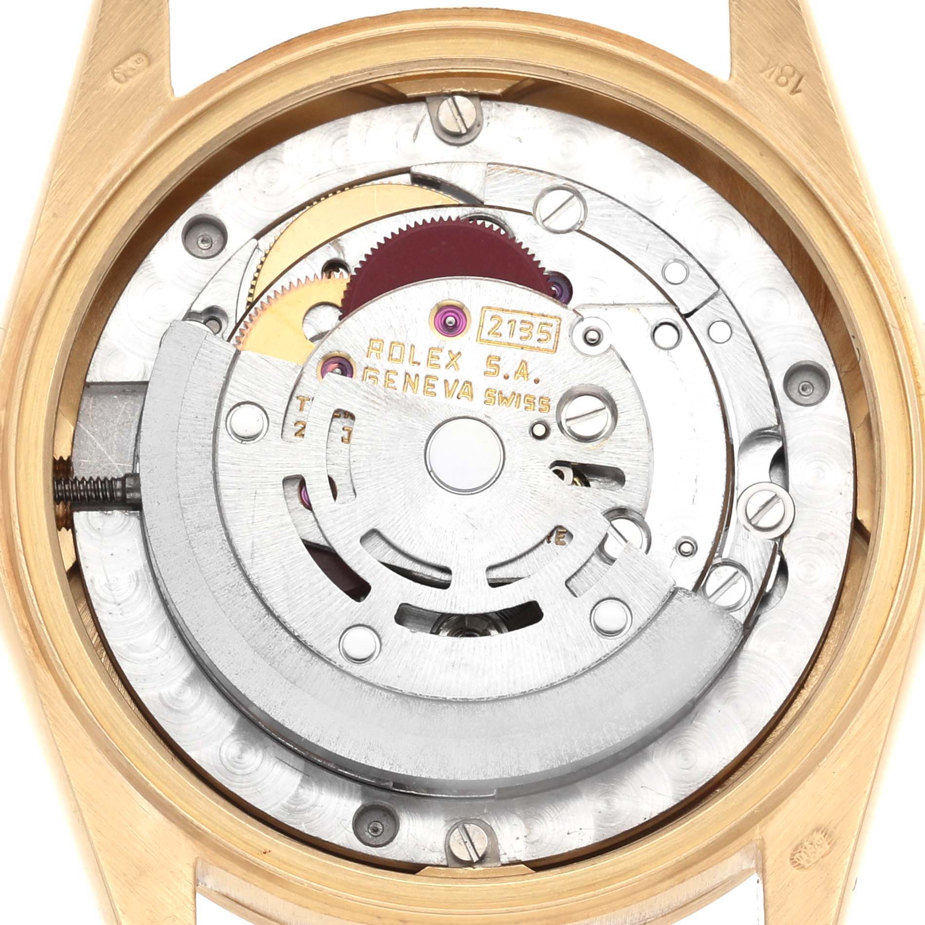 The image shows the movement of a Rolex Mid-Size 68278 Women's Yellow Gold Champagne Dial watch from a back angle, highlighting its intricate mechanism.