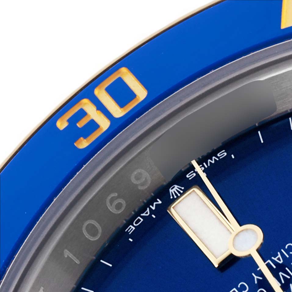 The image shows a close-up of the blue and gold bezel and dial of the Rolex Submariner 126613LB Men's Steel and Gold (two tone) Blue Dial 126613LB Men's Steel and Gold (two tone) Blue Dial watch, highlighting the numbers and markers.