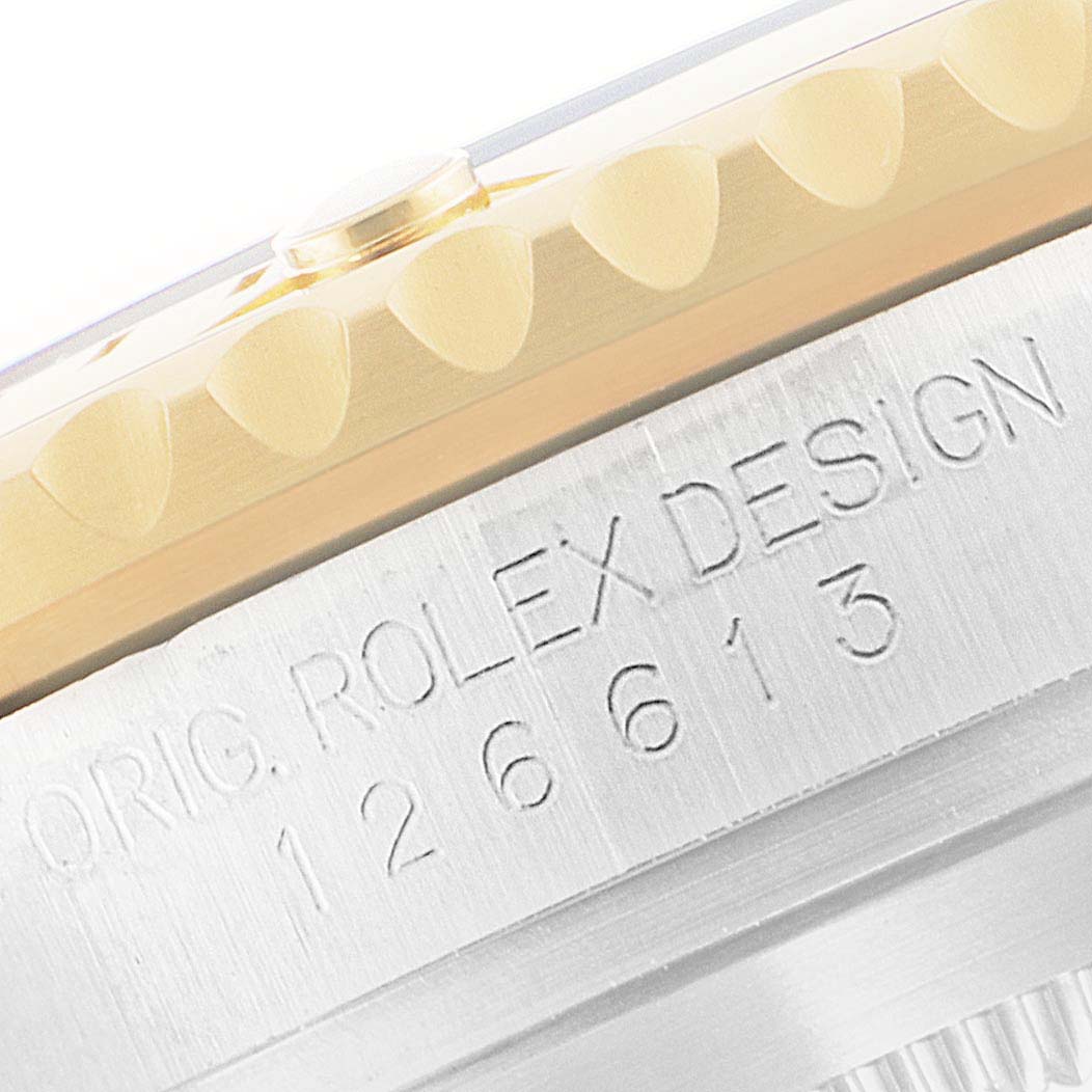 The angle shows the side view of the Rolex Submariner 126613LB Men's Steel and Gold (two tone) Blue Dial 126613LB Men's Steel and Gold (two tone) Blue Dial, featuring the engraved case and the edge of the bezel.