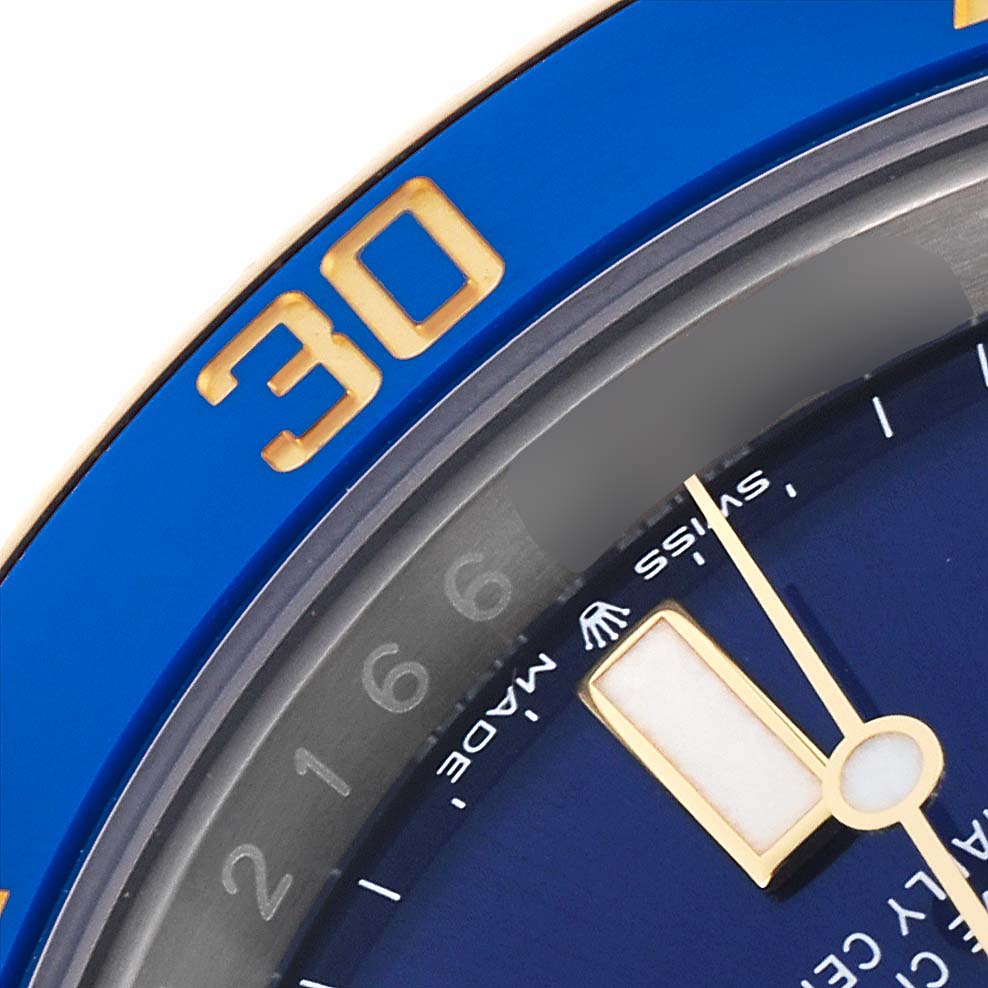 This image shows a close-up of the Rolex Submariner 126613LB Men's Steel and Gold (two tone) Blue Dial 126613LB Men's Steel and Gold (two tone) Blue Dial's blue bezel with the "30" mark and part of the dial and hands.