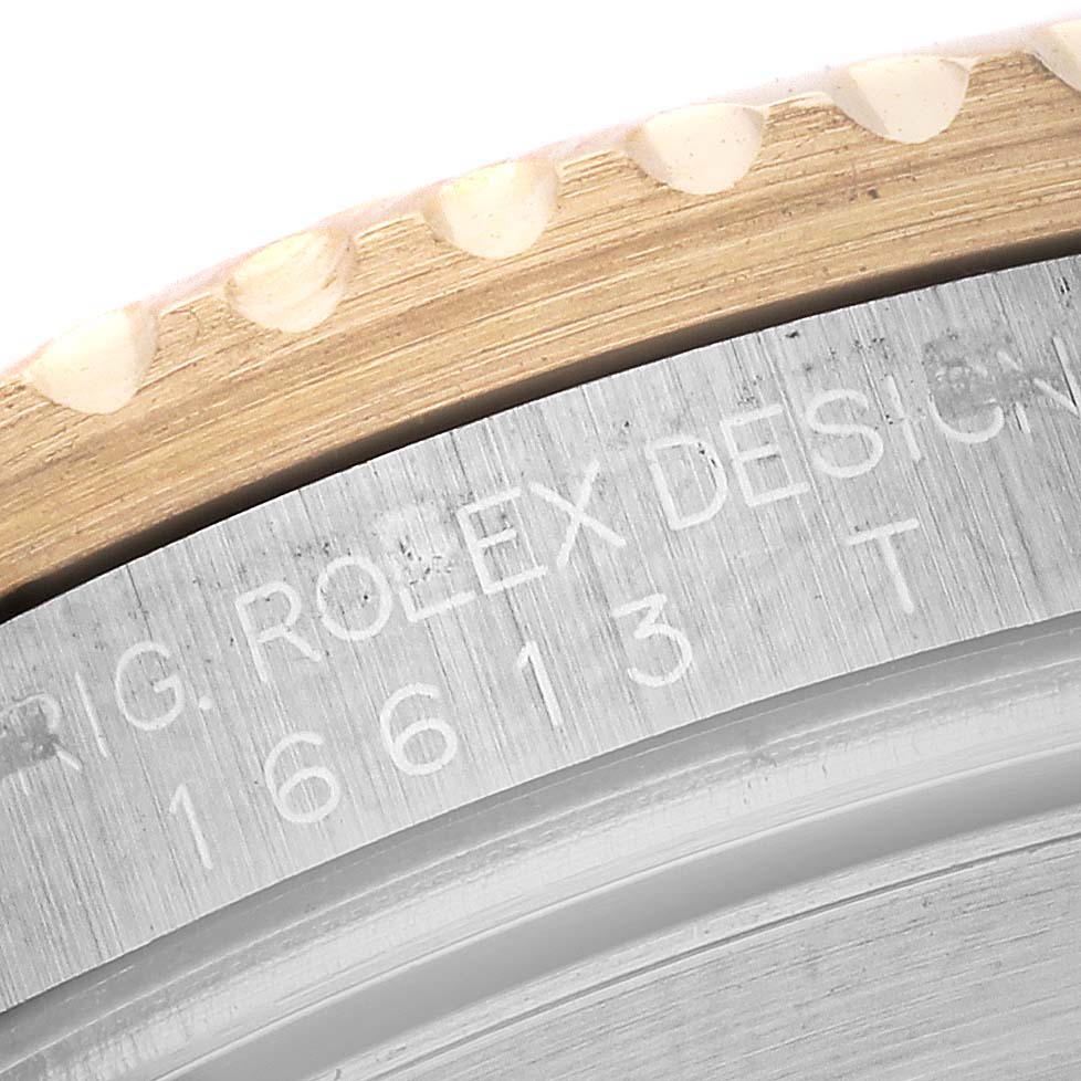 The image shows a close-up of the brushed metal bezel edge and engraved inner rim of the Rolex Submariner 16613 Men's Steel and Gold (two tone) Blue Dial 16613 Men's Steel and Gold (two tone) Blue Dial model 16613.