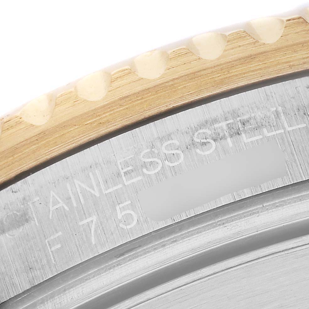 The image shows a close-up of the bezel and engraved edge of a Rolex Submariner 16613 Men's Steel and Gold (two tone) Blue Dial 16613 Men's Steel and Gold (two tone) Blue Dial watch.