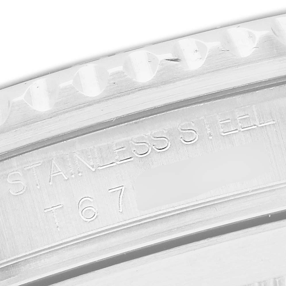 The image shows a close-up of the outer rim and engraved details of the Rolex Submariner 16610 Men's Stainless Steel Black Dial's bezel in stainless steel.