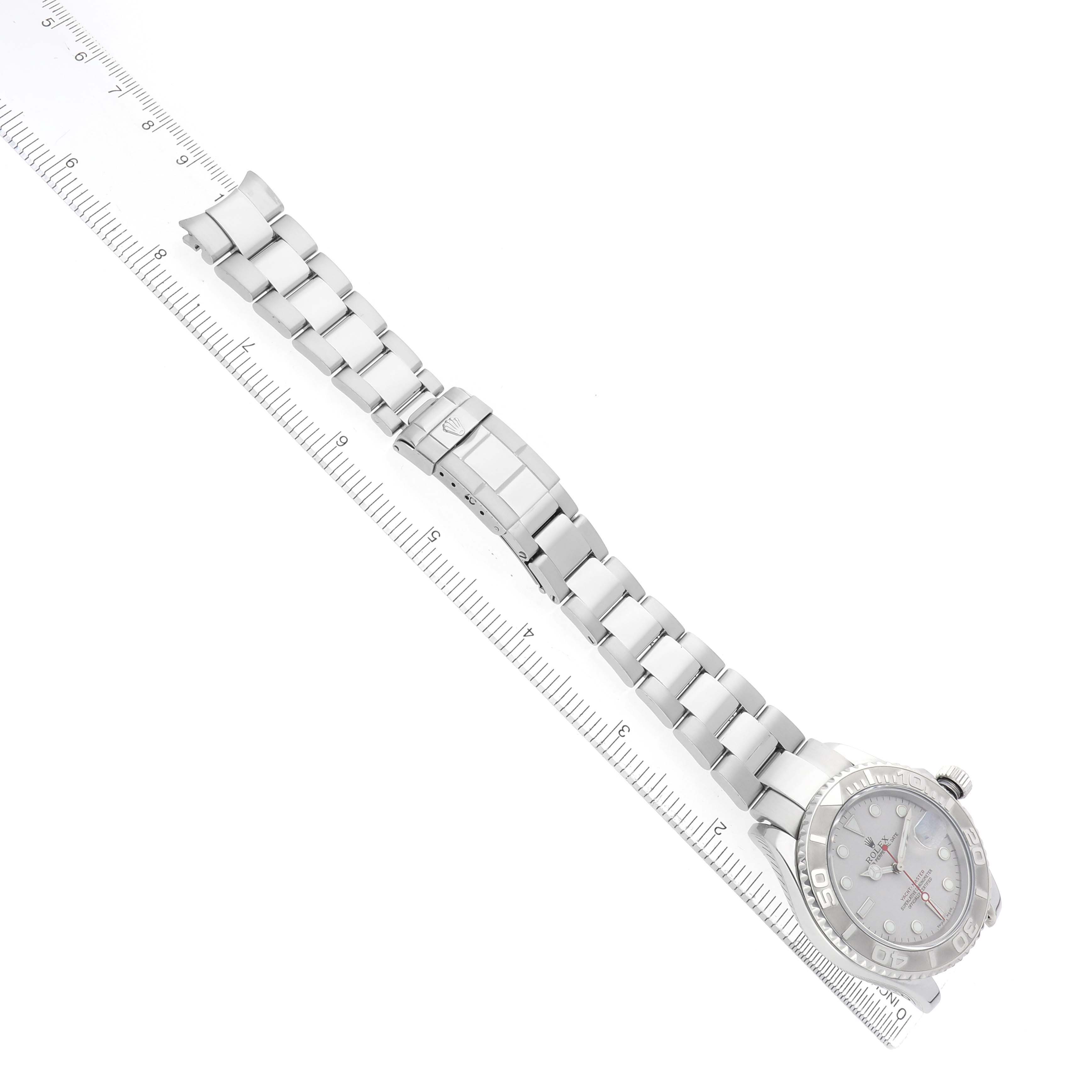 The Rolex Yacht-Master 16622 Men's Stainless Steel Silver Dial watch is shown at an angle, displaying the entire bracelet and clasp alongside a ruler for scale.