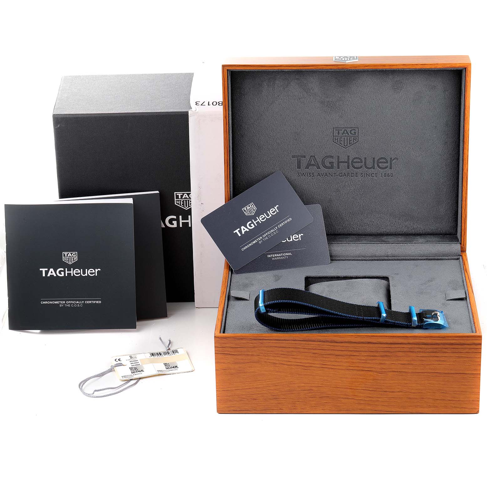 This image shows an angled view of the Tag Heuer Autavia WBE5116.EB0173 Men's Stainless Steel Blue Dial WBE5116.EB0173 Men's Stainless Steel Blue Dial watch box, booklets, strap, and accessories.