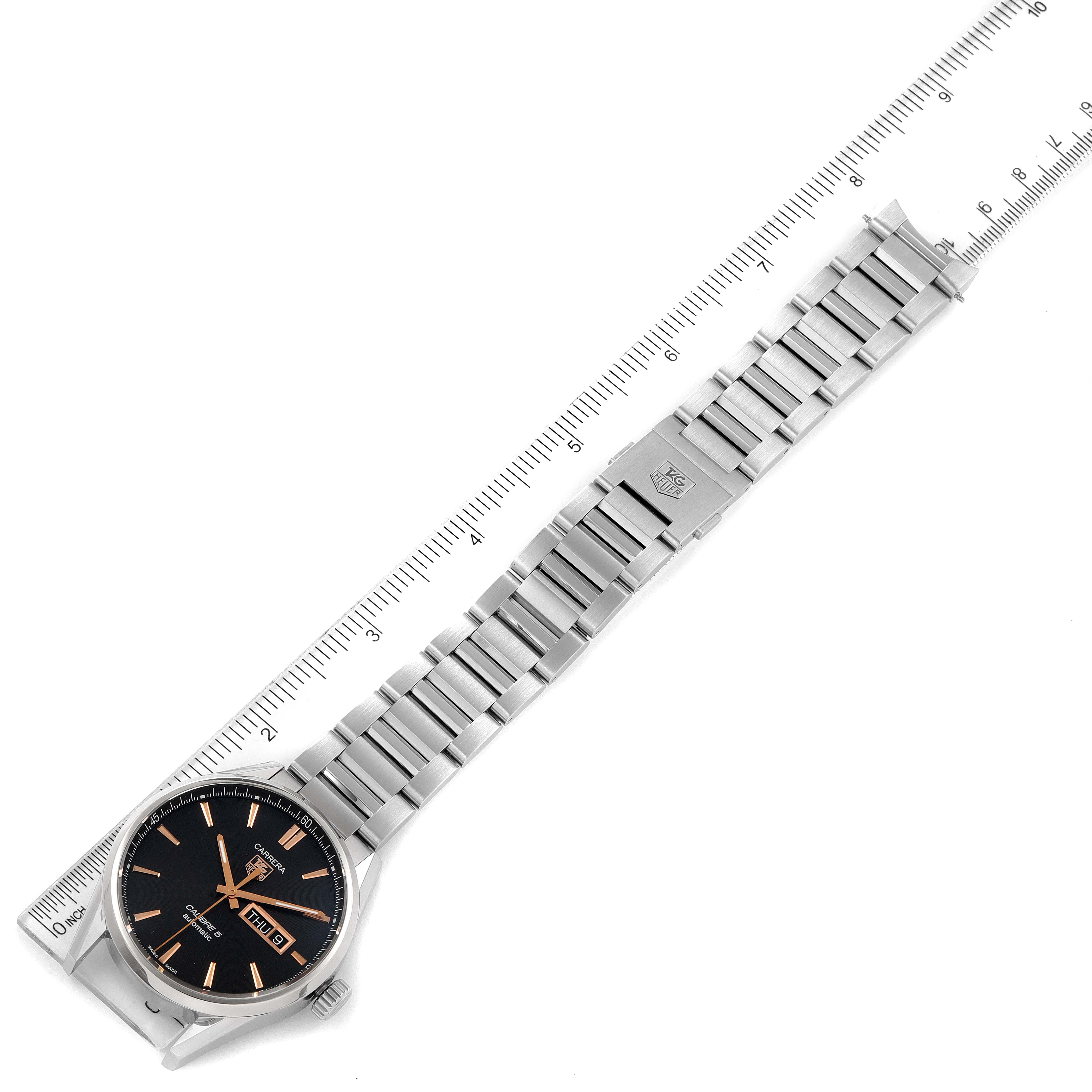 The image shows a top-down view of a Tag Heuer Carrera WAR201C.BA0723 Men's Stainless Steel Grey Dial WAR201C.BA0723 Men's Stainless Steel Grey Dial model watch, including its face, bezel, and full bracelet, next to a ruler for scale.