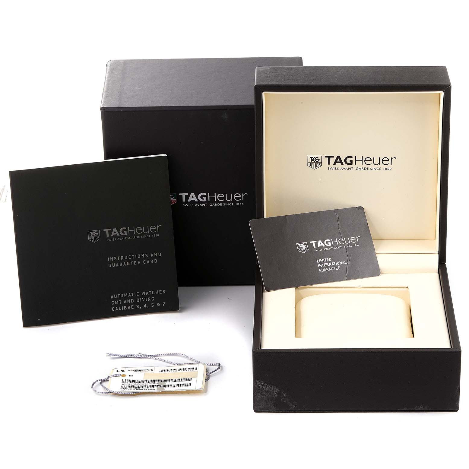 This image shows the packaging contents for a Carrera model by Tag Heuer, including boxes, instruction manuals, a guarantee card, and tags.
