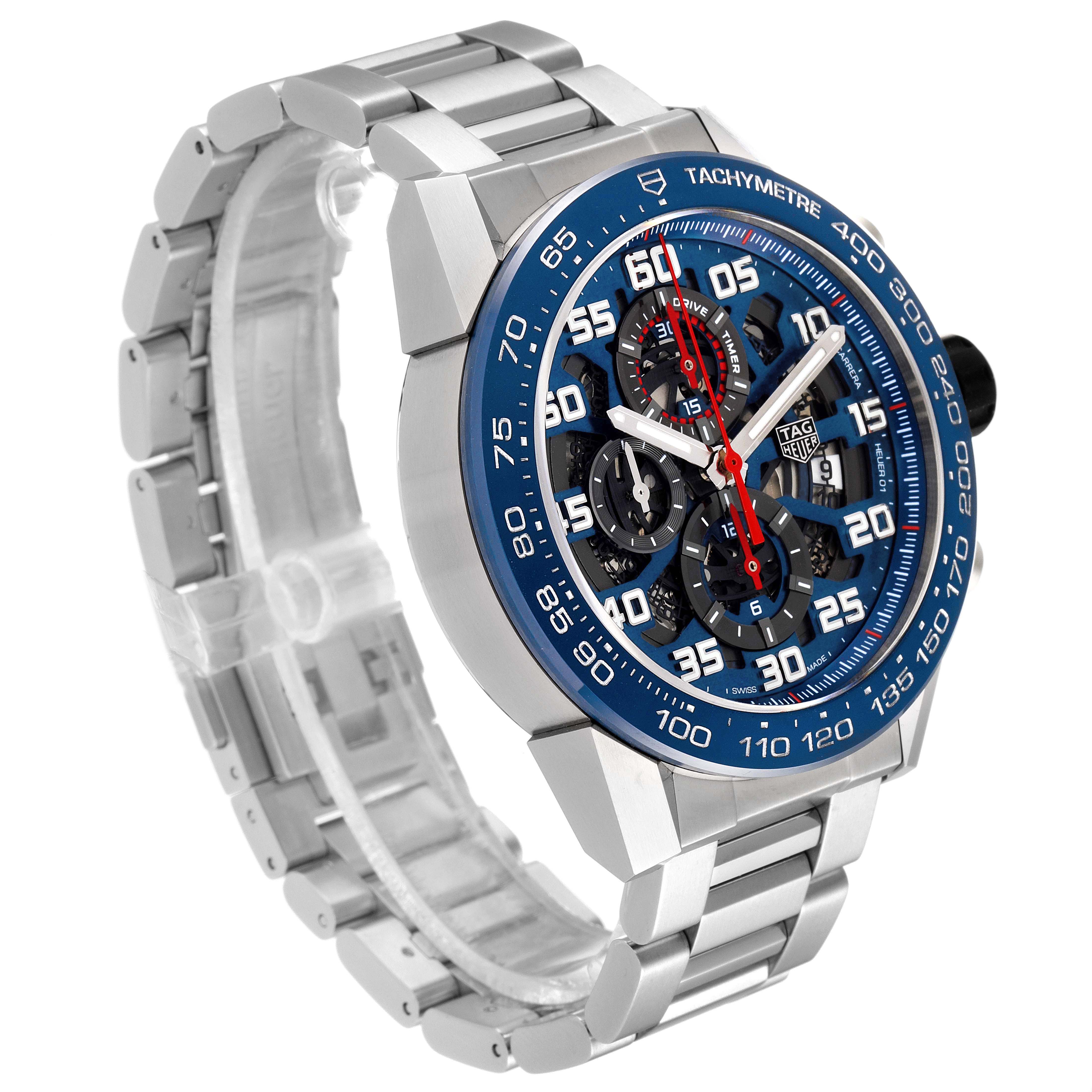 The image shows a side and front angle of a Tag Heuer Carrera CAR2A1K.BA0703 Men's Stainless Steel Blue Dial CAR2A1K.BA0703 Men's Stainless Steel Blue Dial watch with a metal bracelet and a blue tachymeter bezel.