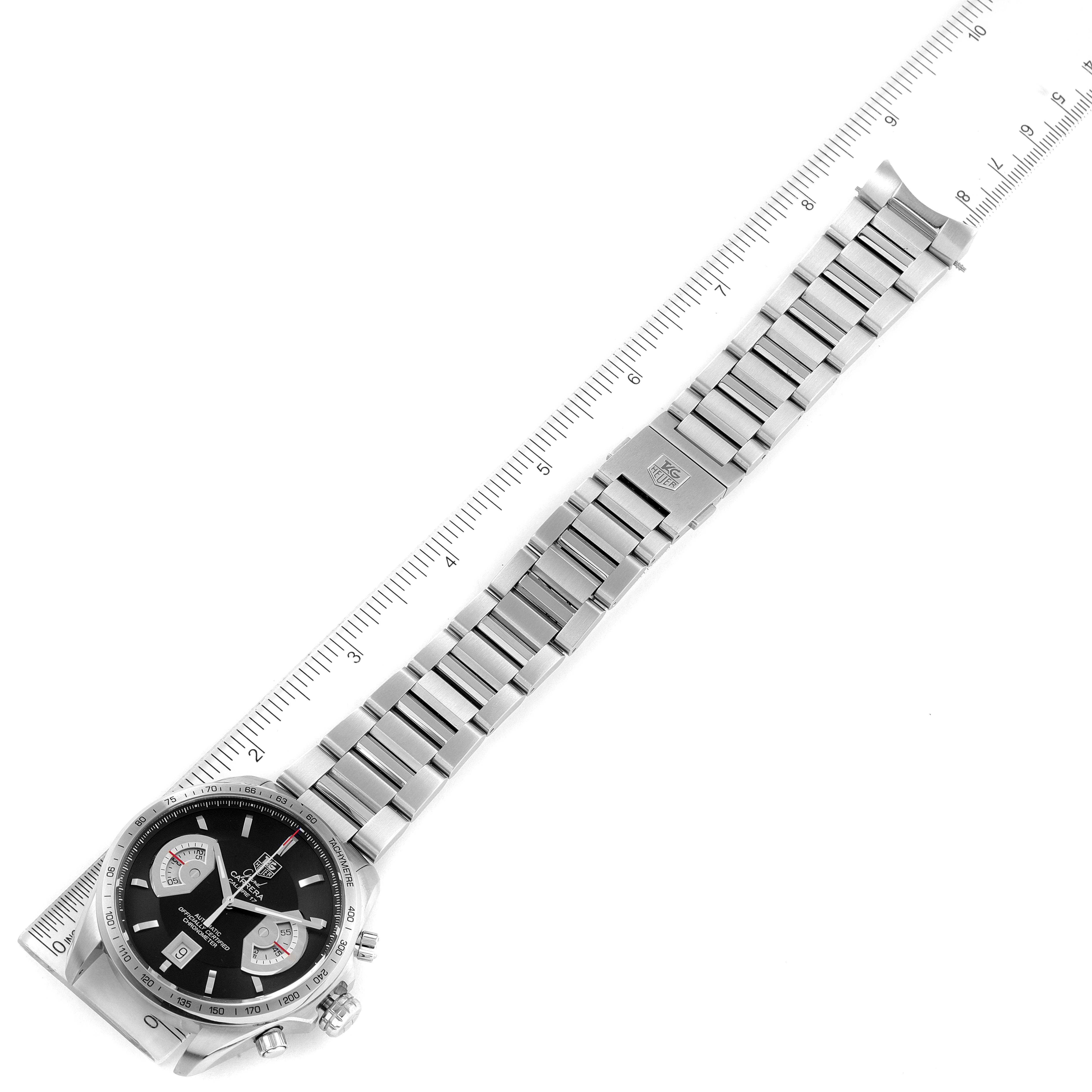 This Tag Heuer Carrera CAV511A Men
s Stainless Steel Black Dial CAV511A Men
s Stainless Steel Black Dial watch is shown in a top-down view with its face, bezel, and full metal bracelet visible next to a ruler.