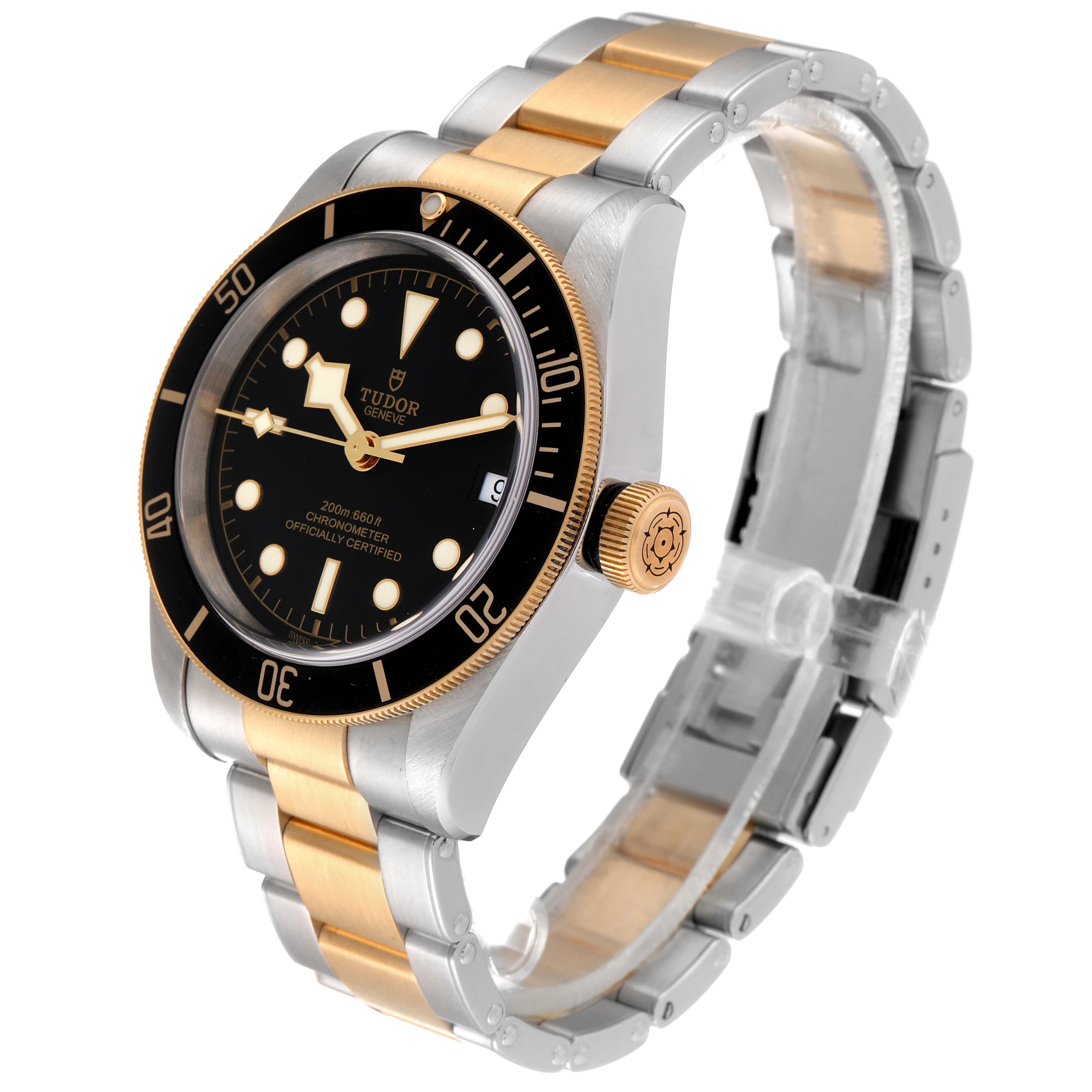 The image shows a side angle of a Tudor Heritage Black Bay 79733 Men's Steel and Gold (two tone) Black Dial 79733 Men's Steel and Gold (two tone) Black Dial watch, highlighting its black dial, bezel, and two-tone metal bracelet.