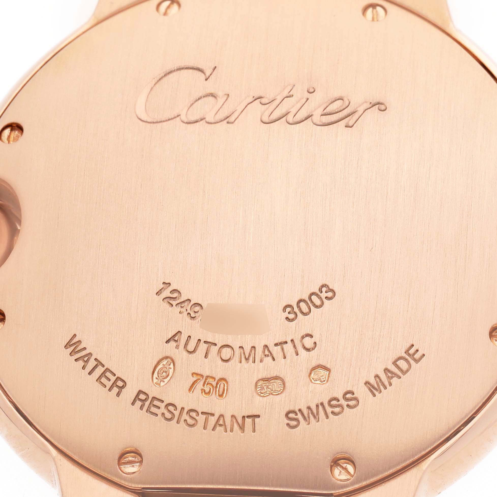 The image shows the back case of a Cartier Ballon Bleu WE900551 Women's Rose Gold Silver Dial watch, displaying the brand name, serial numbers, and engraving details.