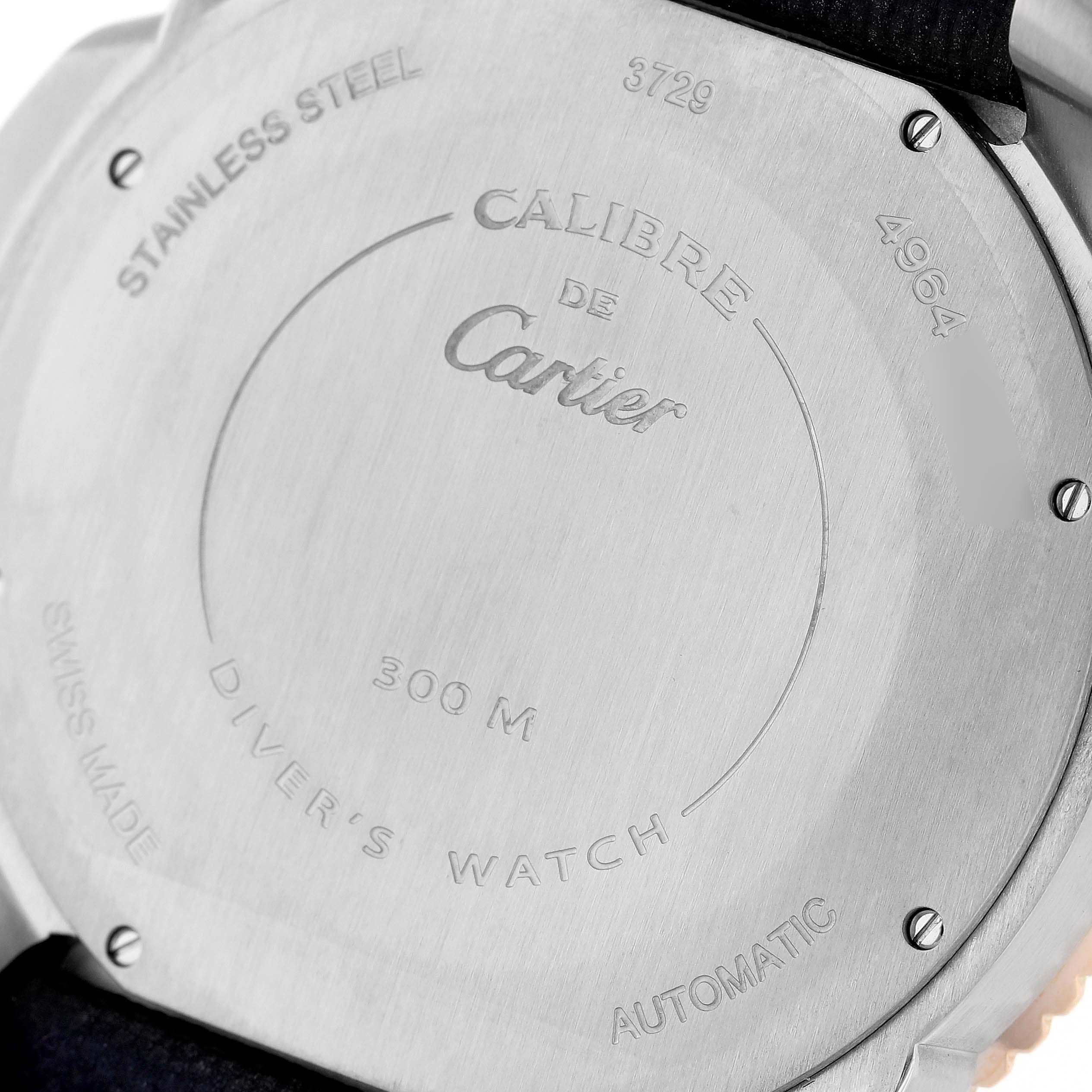 The image shows the case back of the Calibre de Cartier model by Cartier, highlighting its engravings and material.
