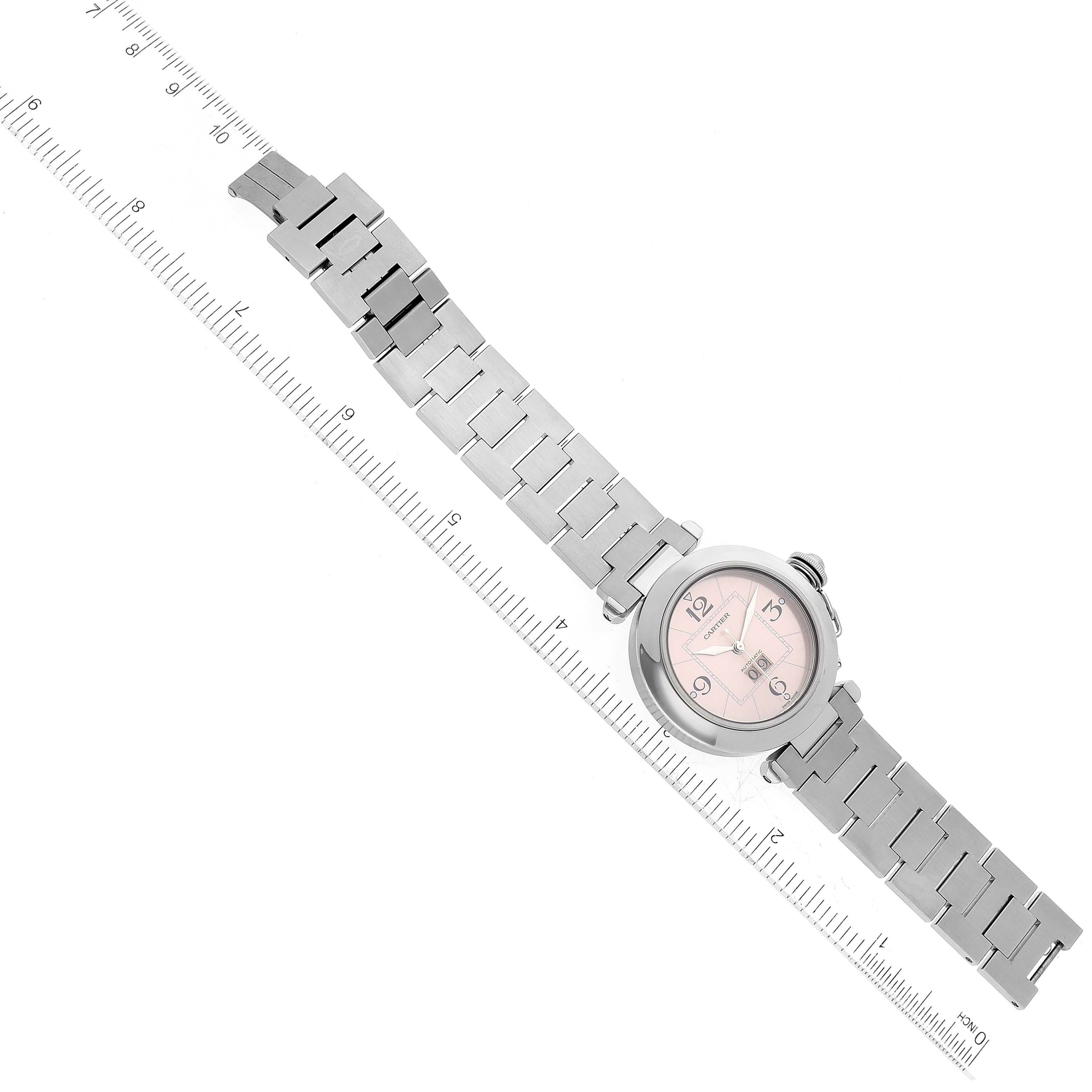 The image displays a top-down view of a Cartier Pasha W31058M7 Women's Stainless Steel Pink Dial W31058M7 Women's Stainless Steel Pink Dial watch, including the face and the full stainless steel bracelet.