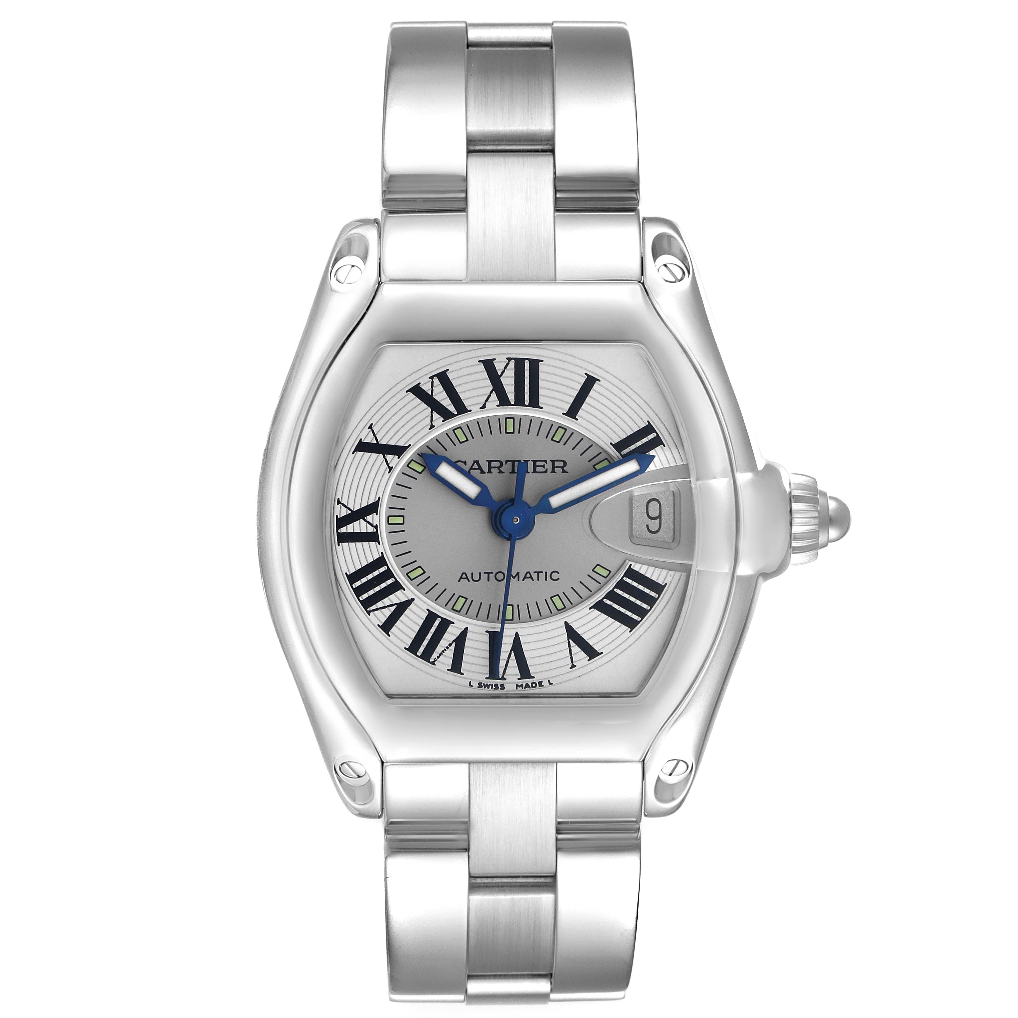 The Cartier Roadster W62025V3 Men's Stainless Steel Silver Dial watch is shown from a top-down angle, displaying the face, Roman numerals, and metal bracelet.