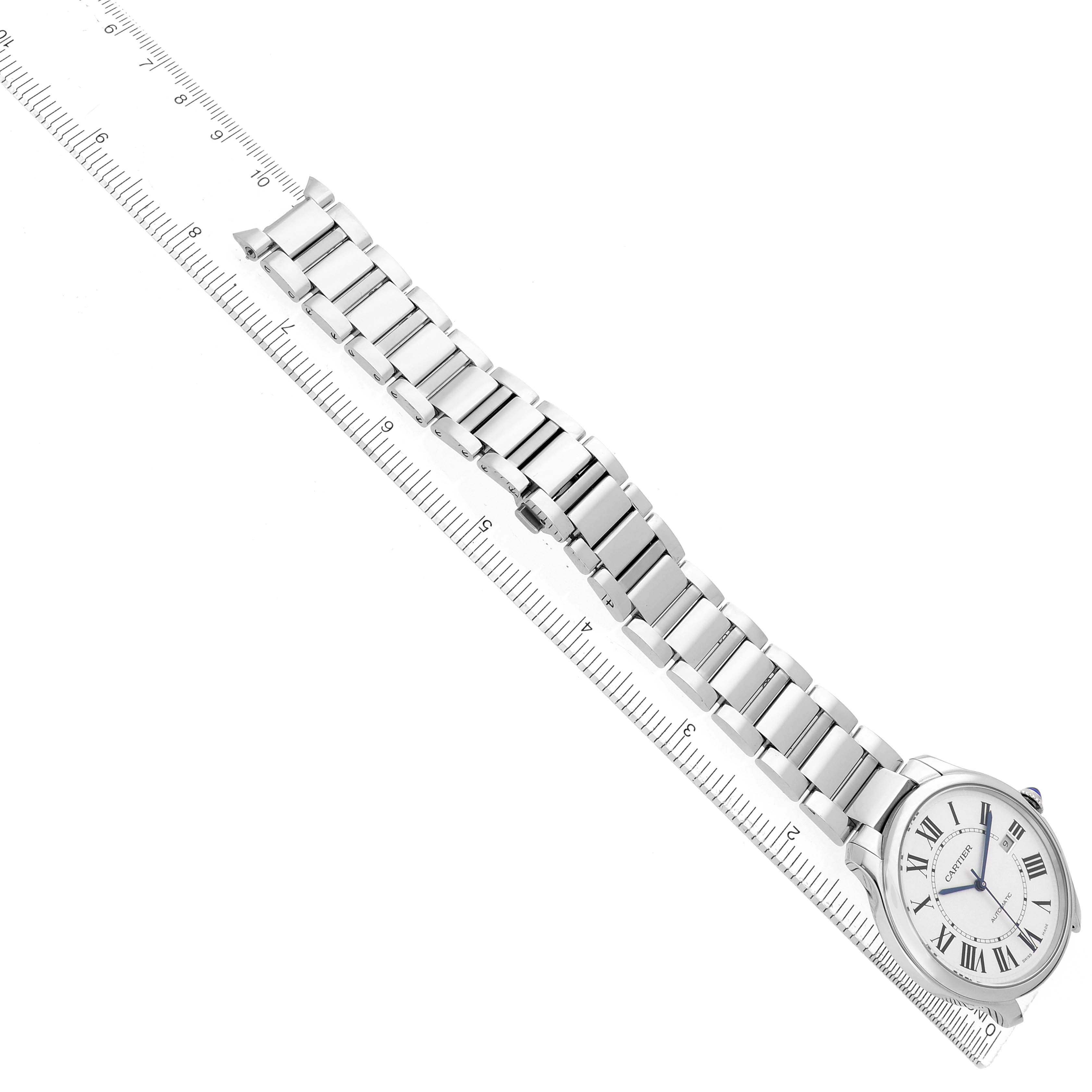The Cartier Ronde WSRN0035 Men's Stainless Steel Silver Dial watch is shown in a top-down angle displaying the watch face and full metal bracelet on a ruler.