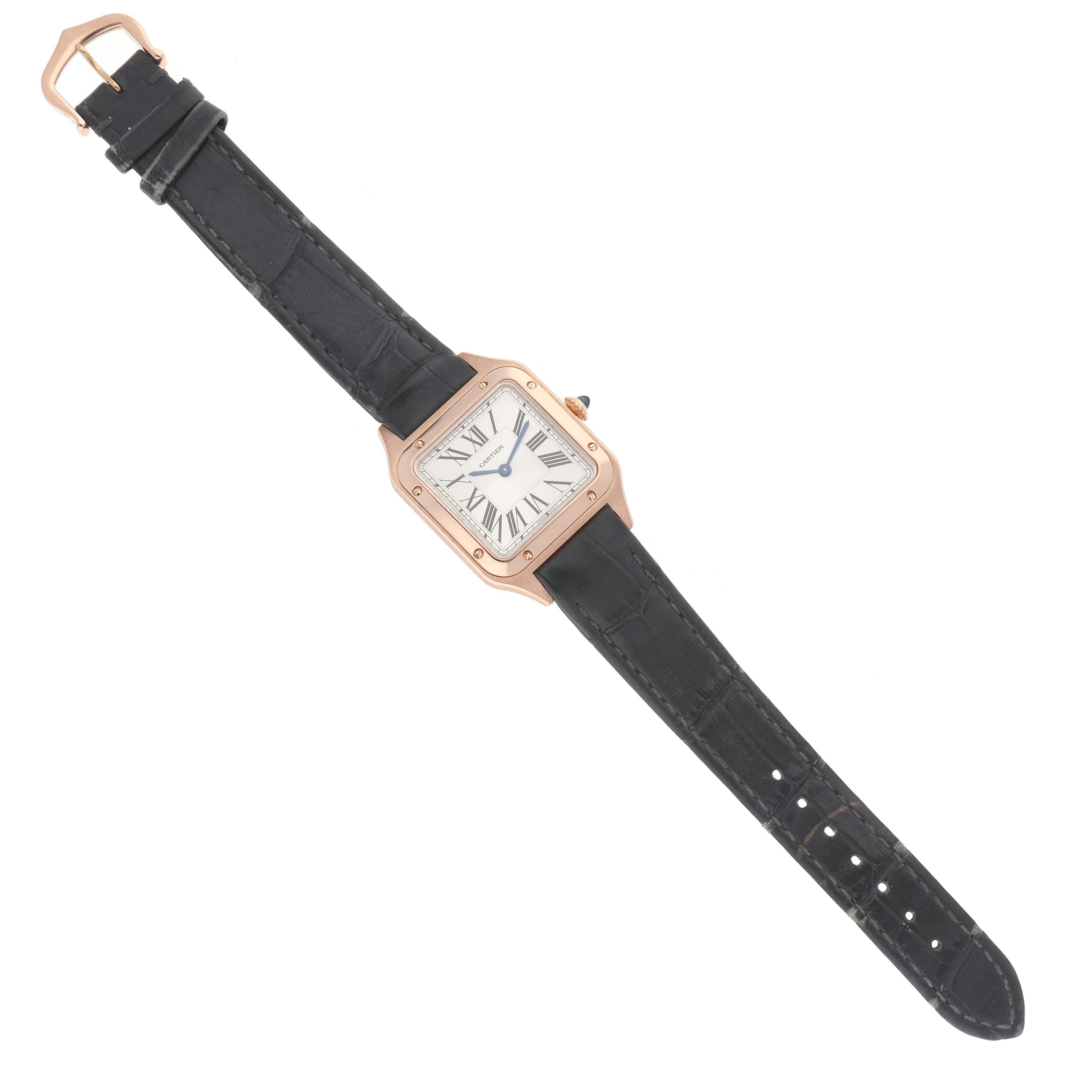 The Cartier Santos WGSA0022 Women's Rose Gold Silver Dial watch is shown from a top-down angle, highlighting its square face, Roman numerals, and black leather strap.