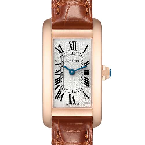 The image shows a Cartier Tank Americaine W2607456 Women's Rose Gold Silver Dial watch from a front angle, highlighting its rectangular face, Roman numerals, blue hands, and leather strap.