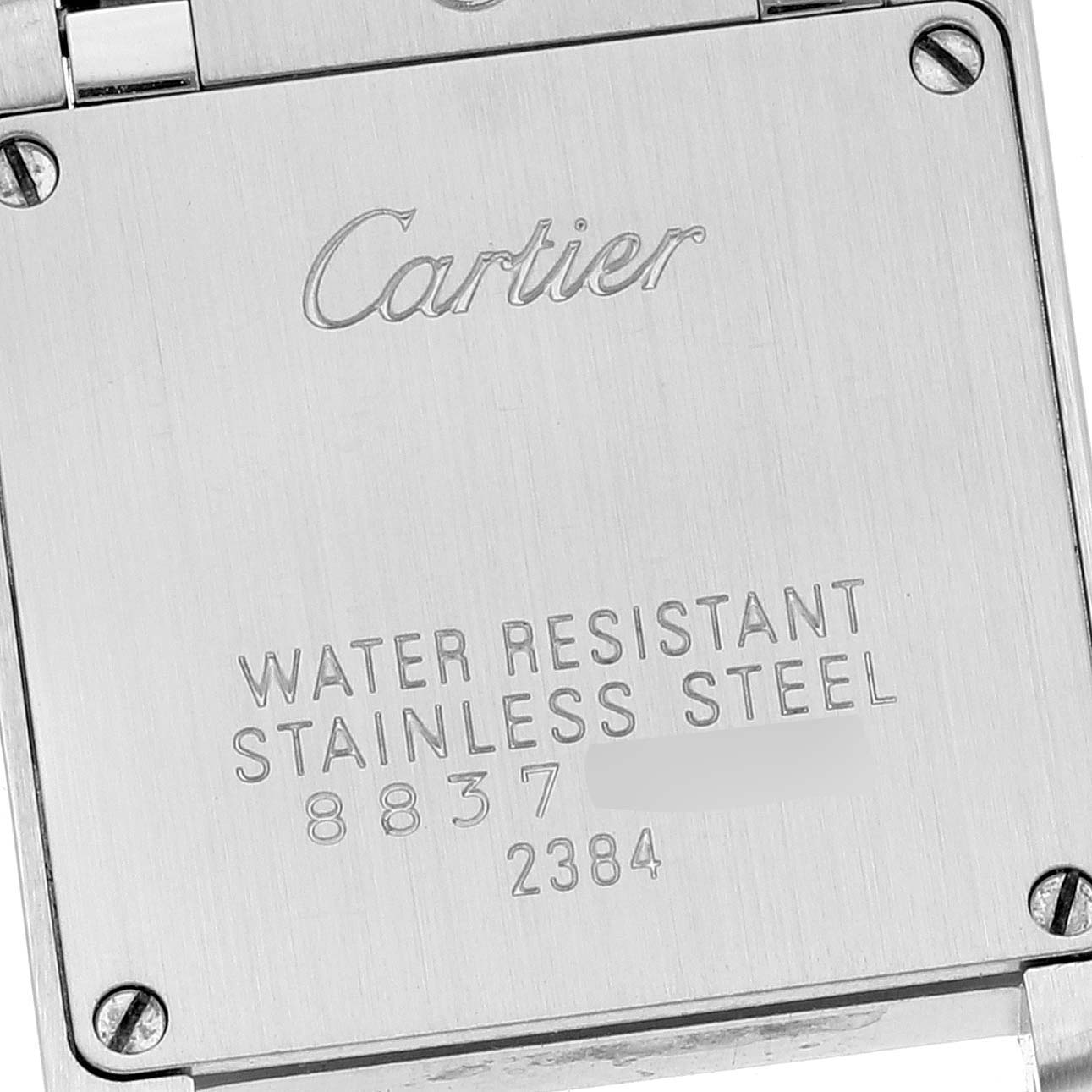 The image shows the stainless steel case back of a Cartier Tank Francaise W51028Q3 Women's Stainless Steel Mother of Pearl Dial W51028Q3 Women's Stainless Steel Mother of Pearl Dial watch, displaying brand inscription and specifications.