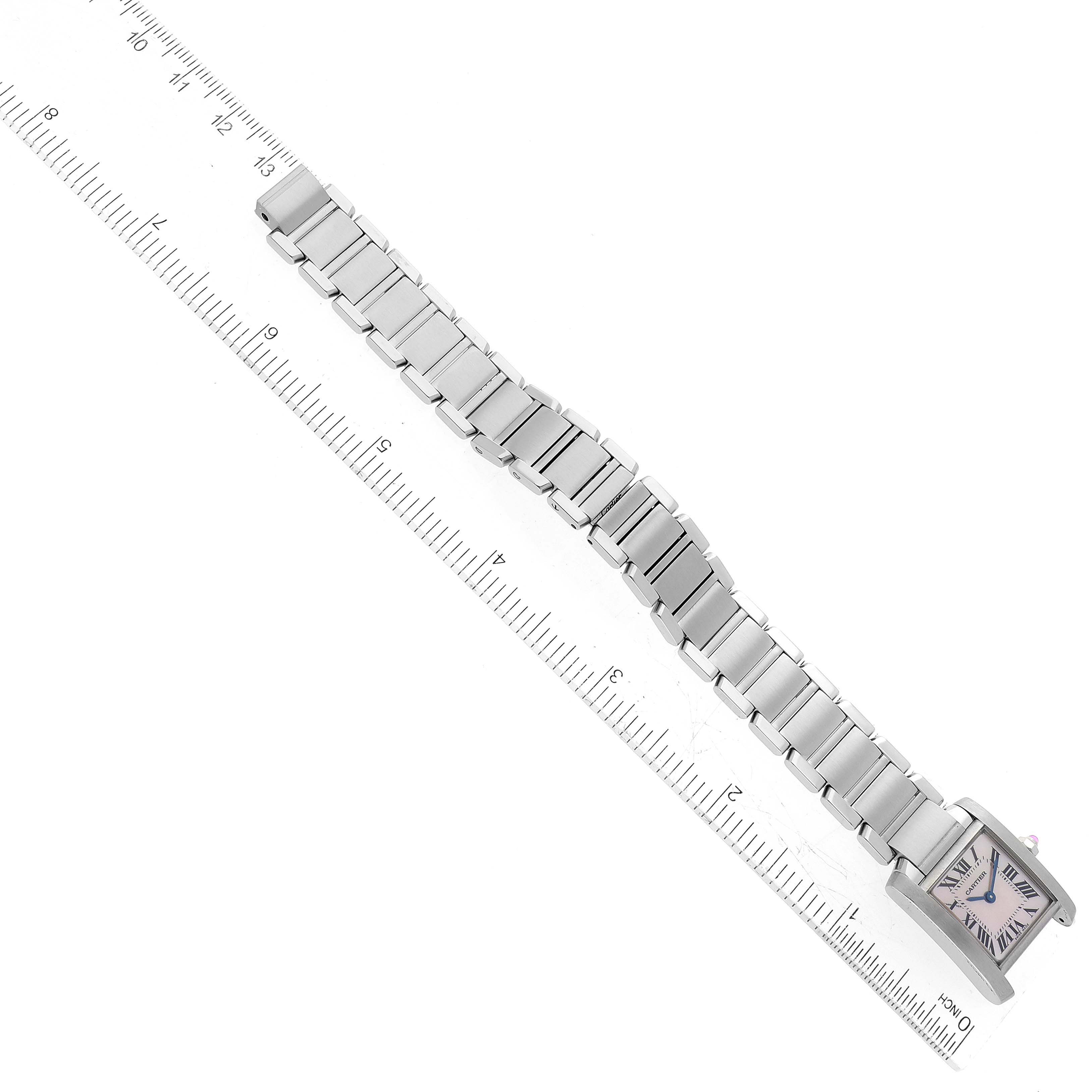 The Cartier Tank Francaise W51028Q3 Women's Stainless Steel Mother of Pearl Dial W51028Q3 Women's Stainless Steel Mother of Pearl Dial watch is shown from an overhead angle, displaying its silver bracelet and square face next to a ruler.