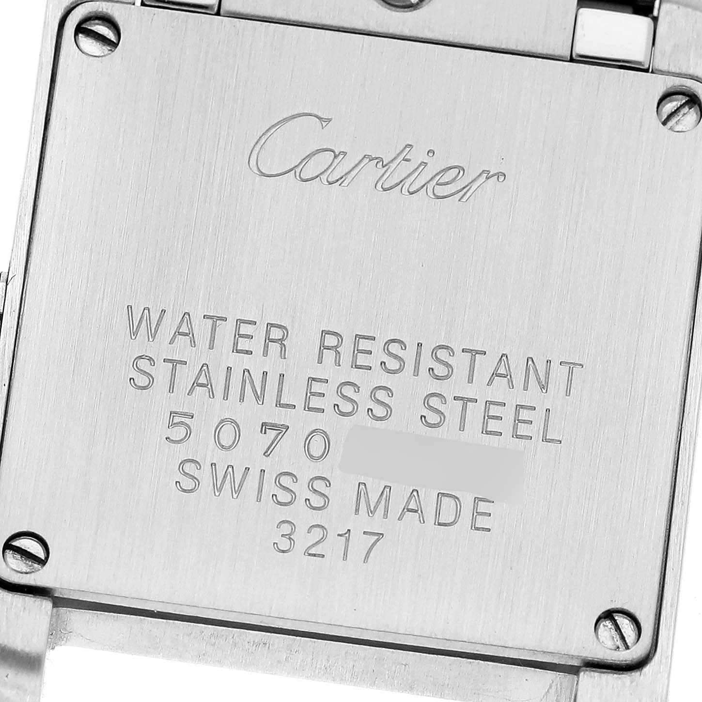 The image shows the back of a Cartier Tank Francaise WE110004 Women
s Steel and Gold (two tone) Silver Dial WE110004 Women
s Steel and Gold (two tone) Silver Dial watch, focusing on the engraved details and screws.