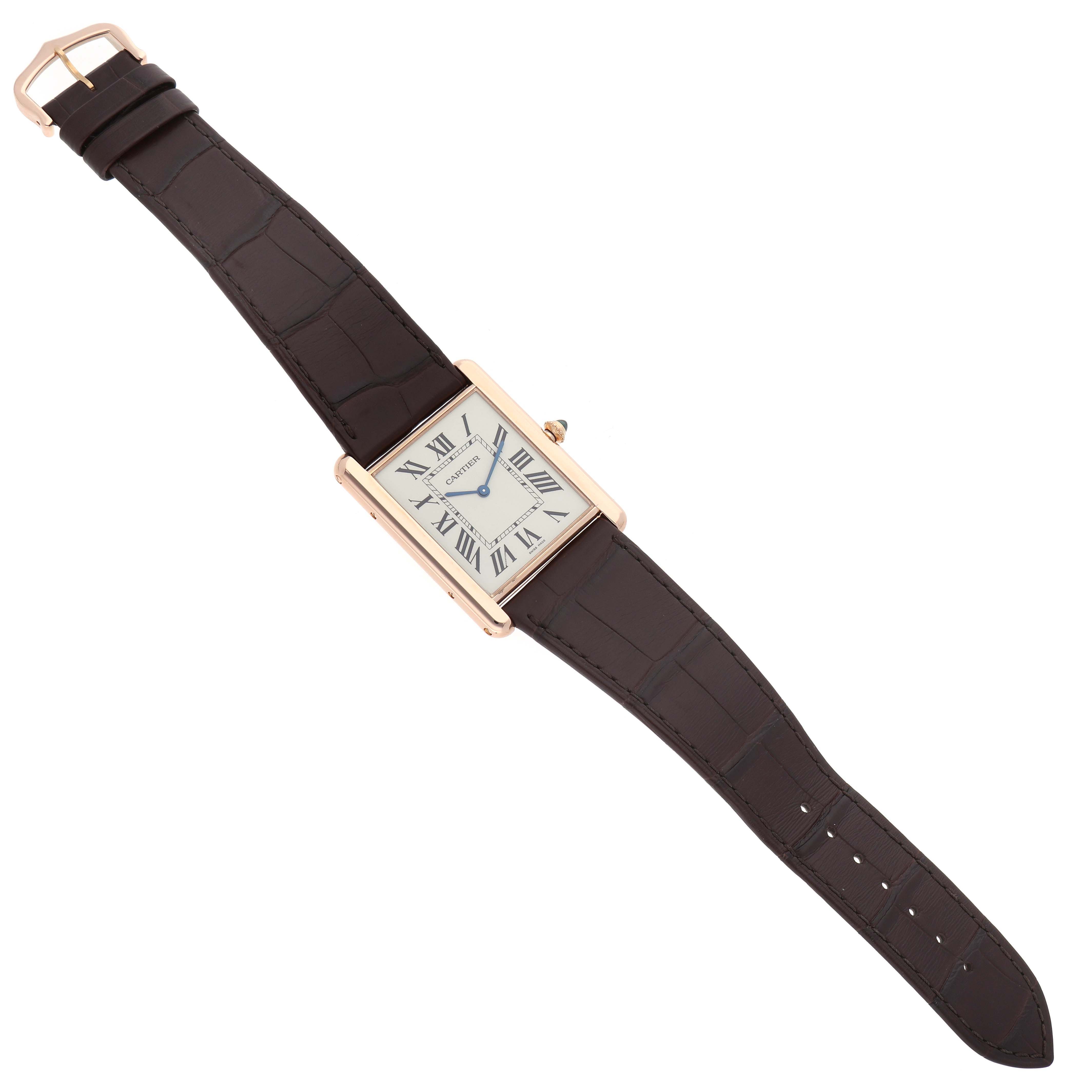 The Cartier Tank Louis W1560017 Men's Rose Gold Silver Dial watch is shown from a top-down angle, displaying its face, case, and leather strap.