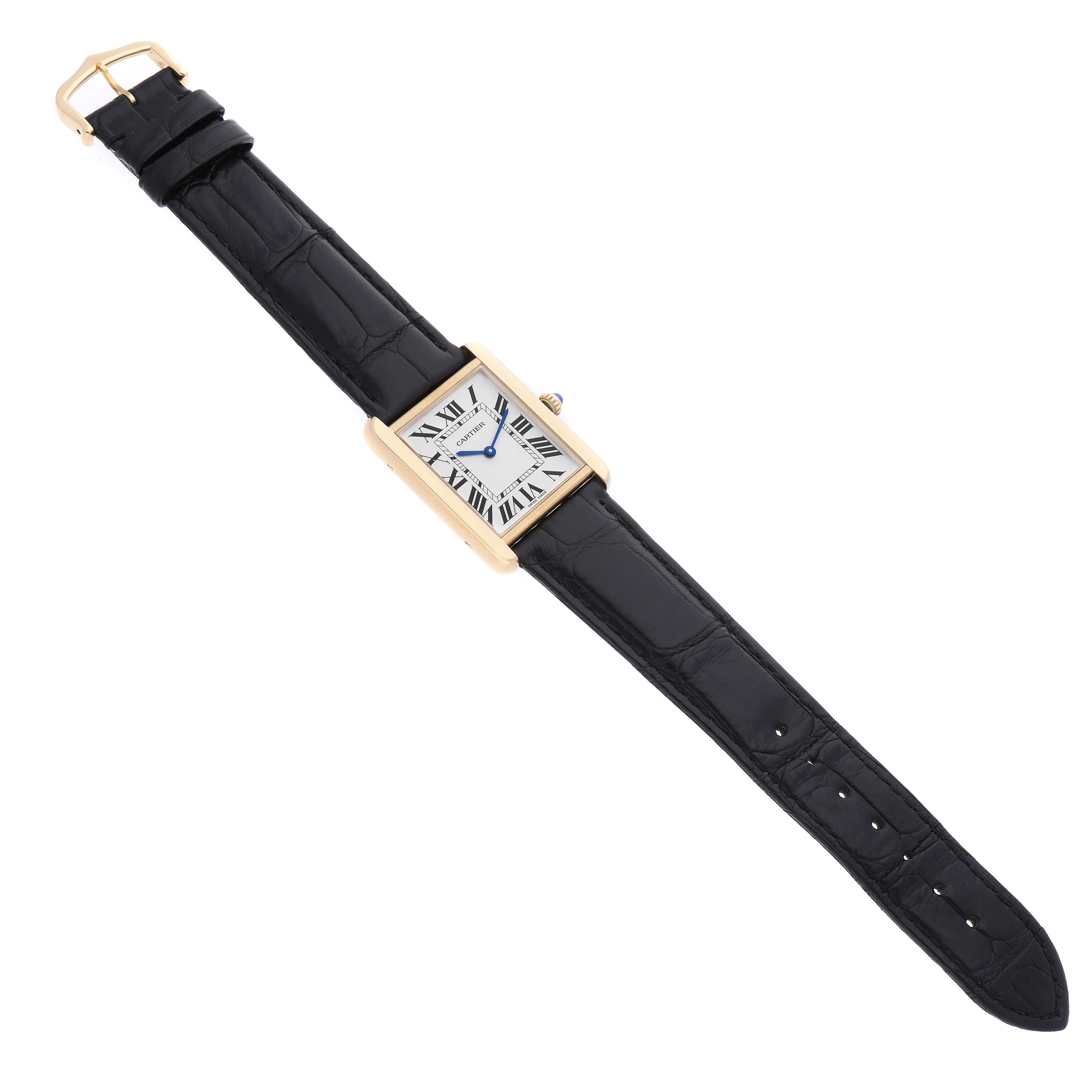 The Cartier Tank Solo W5200004 Men's Yellow Gold Silver Dial watch is shown from a top-down angle, revealing its rectangular case, dial, hands, and black leather strap.