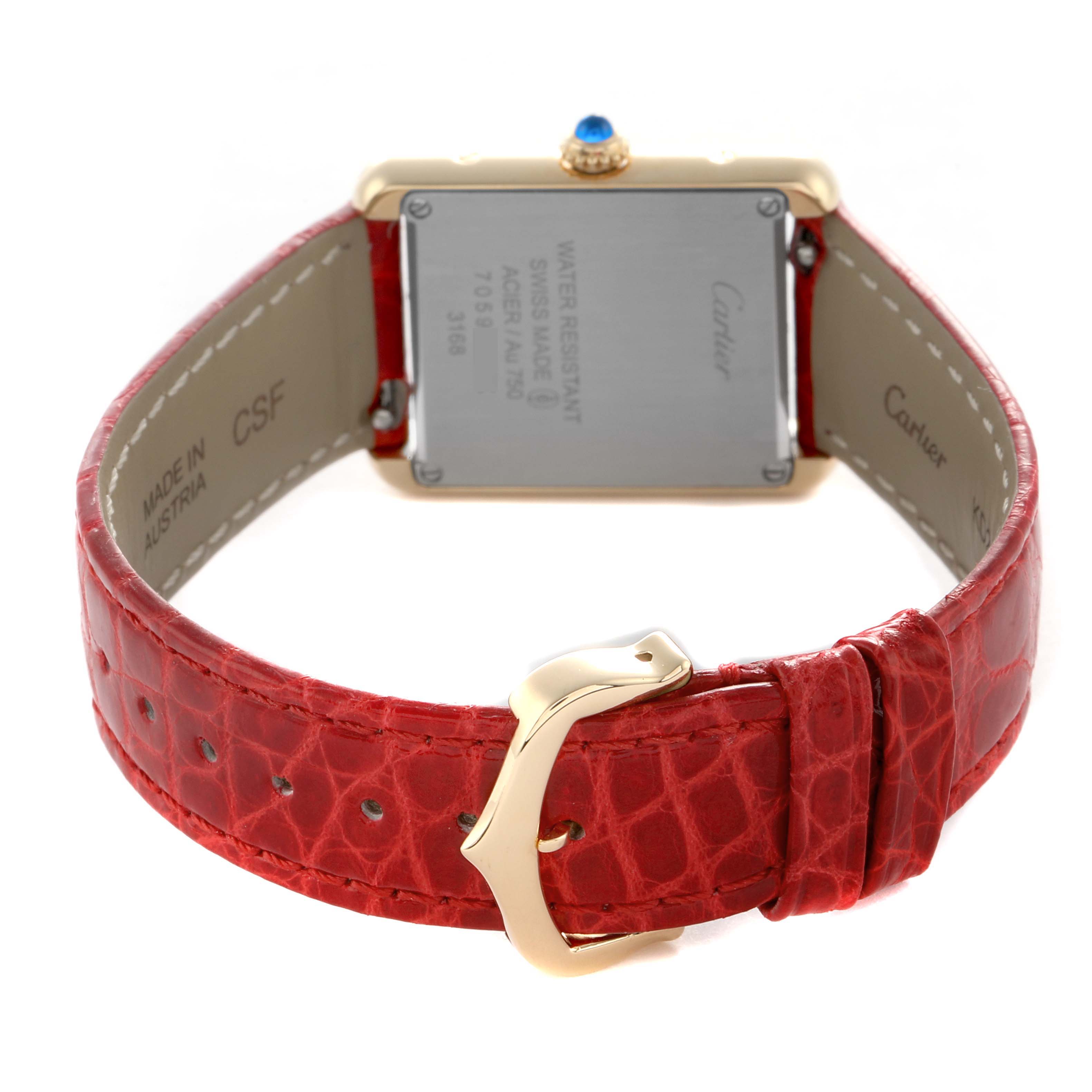 The Cartier Tank Solo W5200002 Women's Yellow Gold Silver Dial is shown from the back, highlighting the case back, red strap, and buckle.