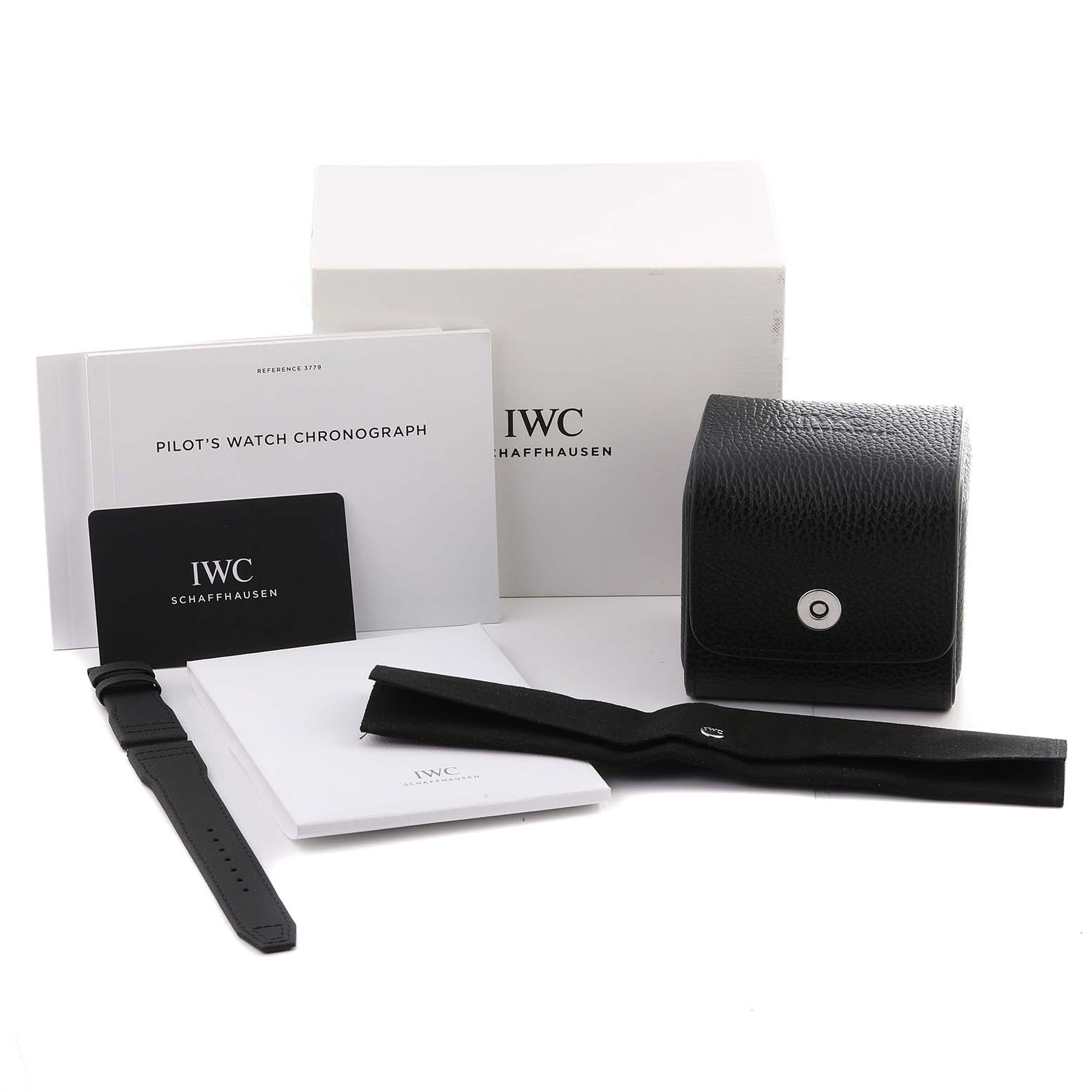 The image shows IWC Pilot IW377903 Men's Titanium Grey Dial watch accessories, including a strap, box, pouches, and manuals from a slightly elevated angle.