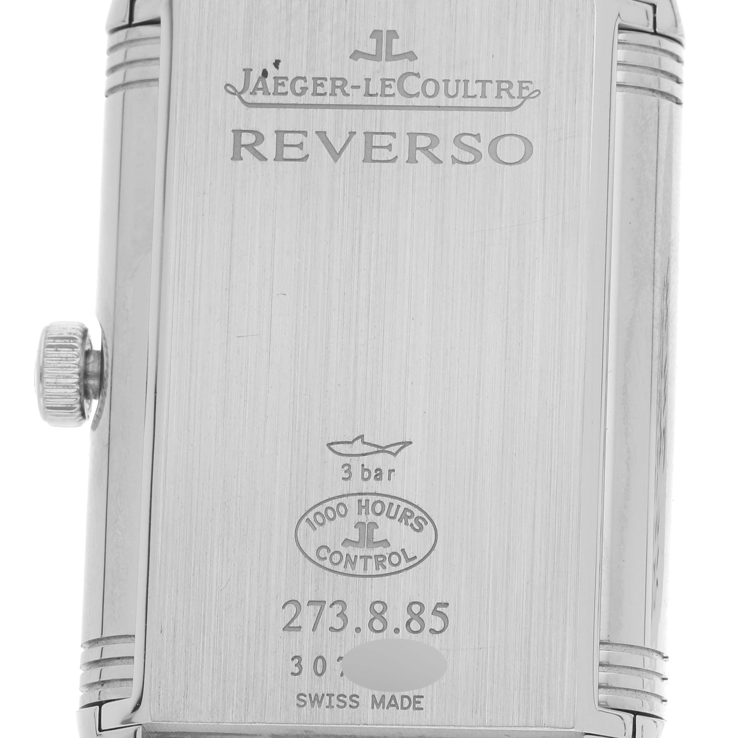 The image shows the back case and crown of a Jaeger-LeCoultre Reverso watch.