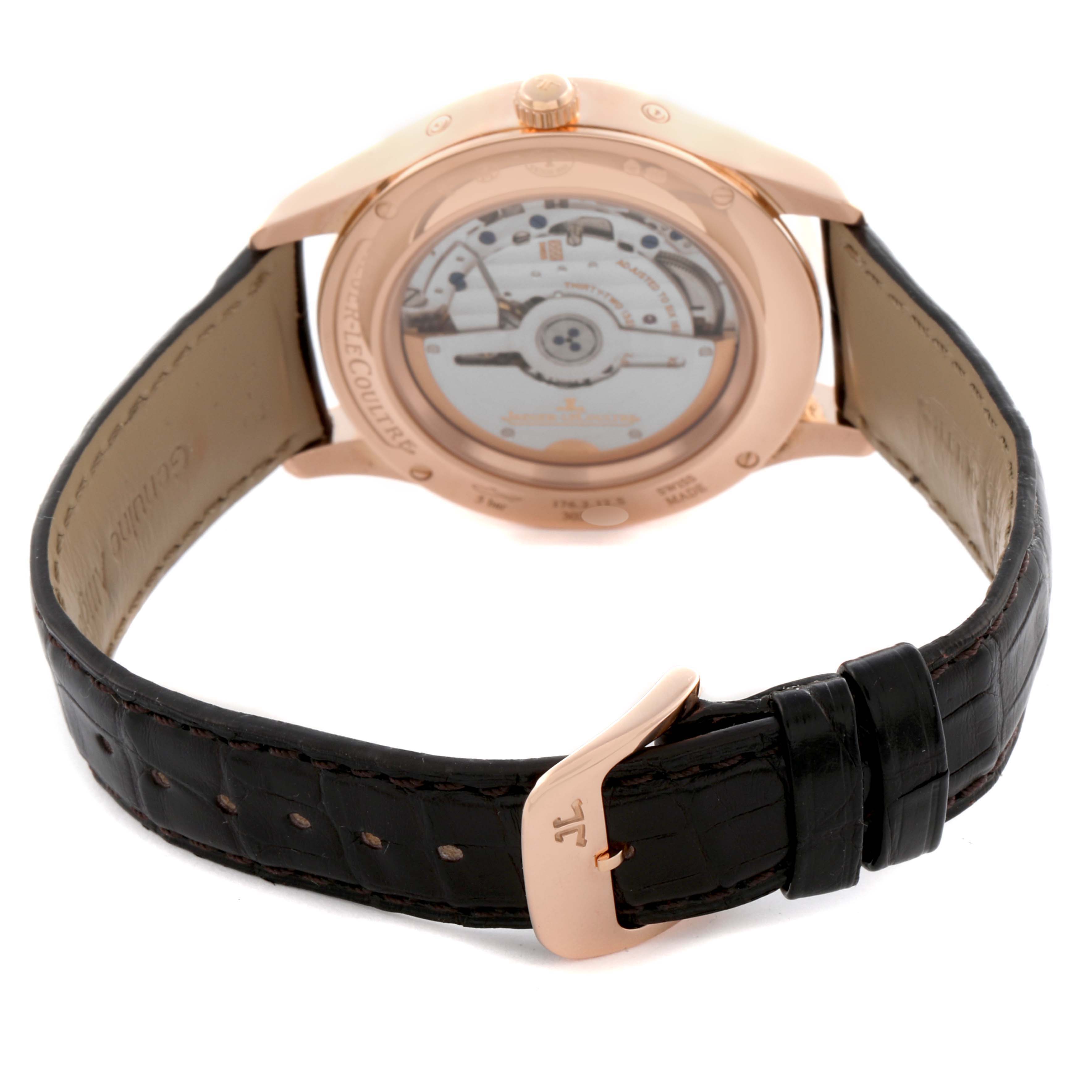 The Jaeger LeCoultre Master Q1552520 Men's Rose Gold Silver Dial watch is shown from the back, displaying its open case back and leather strap with a buckle.