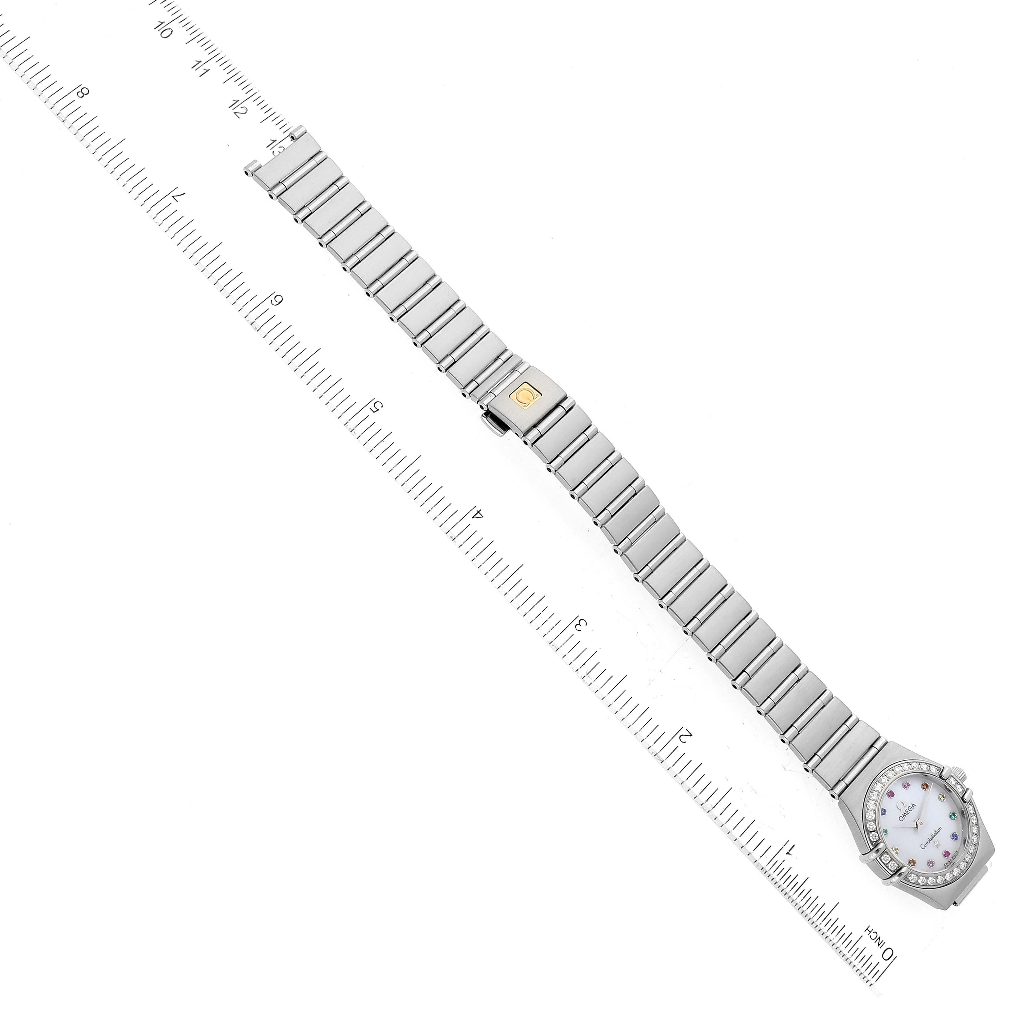The image shows the Omega 1460.79.00 Women's Stainless Steel Mother of Pearl Dial 1460.79.00 Women's Stainless Steel Mother of Pearl Dial Constellation Iris 1460.79.00 watch laid flat with its entire steel band and face visible, next to a ruler.