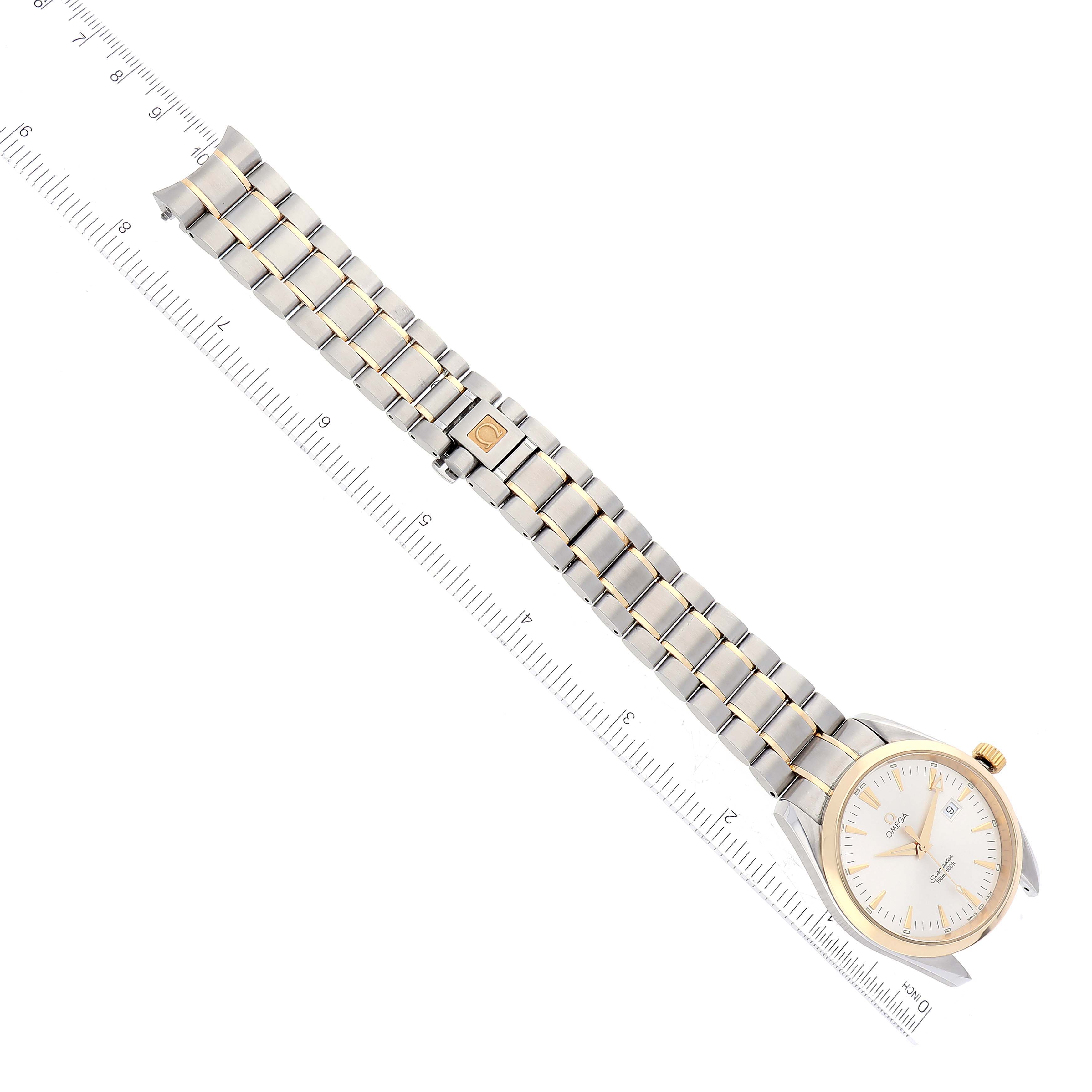 The image shows an Omega Aqua Terra 2317.30.00 Men's Steel and Gold (two tone) Silver Dial 2317.30.00 Men's Steel and Gold (two tone) Silver Dial watch laid horizontally, displaying its face, bezel, and metal bracelet next to a ruler for scale.