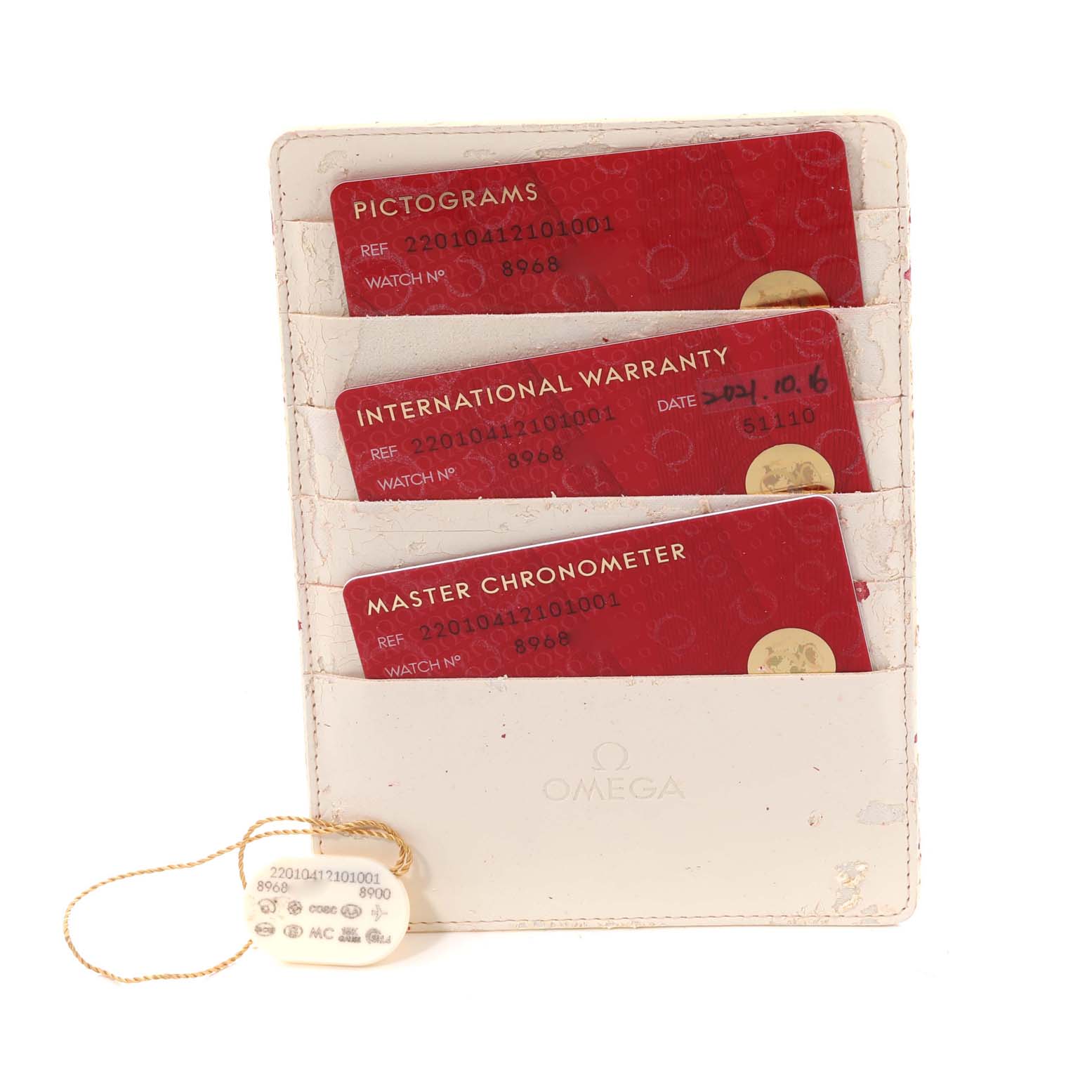 The image shows an Omega Aqua Terra 220.10.41.21.01.001 Men's Stainless Steel Black Dial 220.10.41.21.01.001 Men's Stainless Steel Black Dial model's warranty cards and tags in a white cardholder.