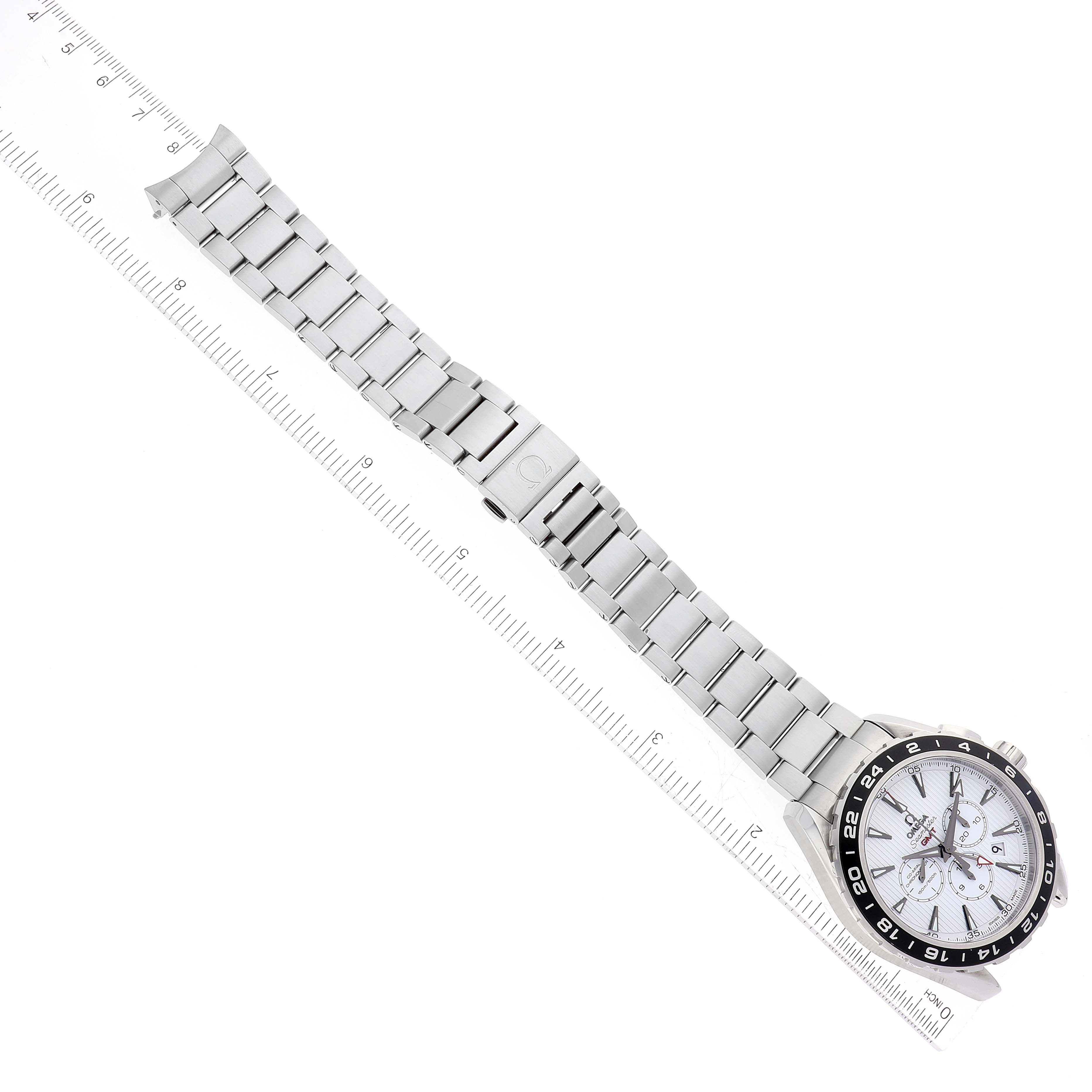 The image shows the Omega Seamaster 231.10.44.52.04.001 Men
s Stainless Steel White Dial 231.10.44.52.04.001 Men
s Stainless Steel White Dial watch laid flat, highlighting its face, bracelet, and clasp, with a ruler for scale.