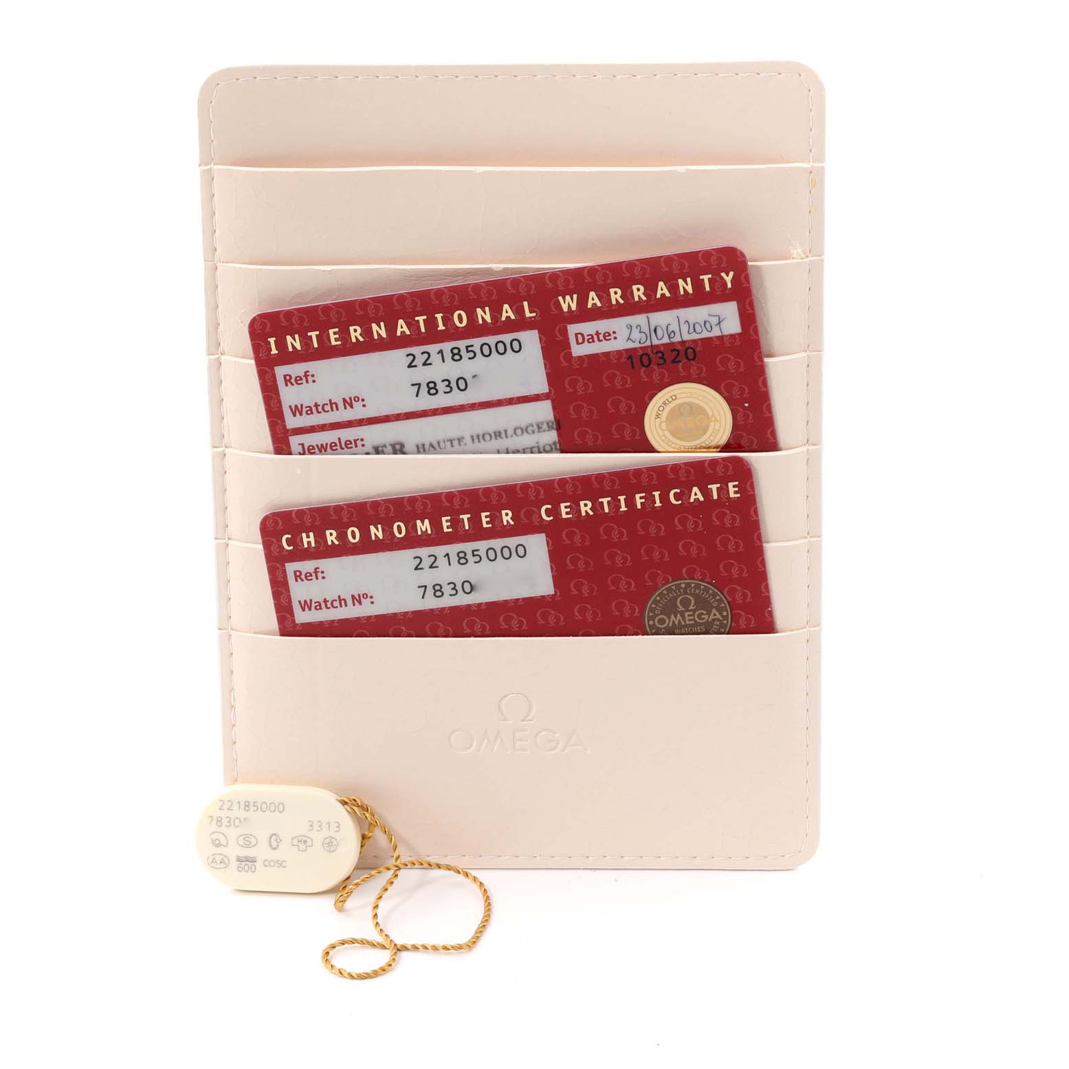 The image shows the warranty cards and tags for the Omega Planet Ocean 2218.50.00 Men
s Stainless Steel Black Dial 2218.50.00 Men
s Stainless Steel Black Dial watch model, along with a holder displaying the Omega logo.