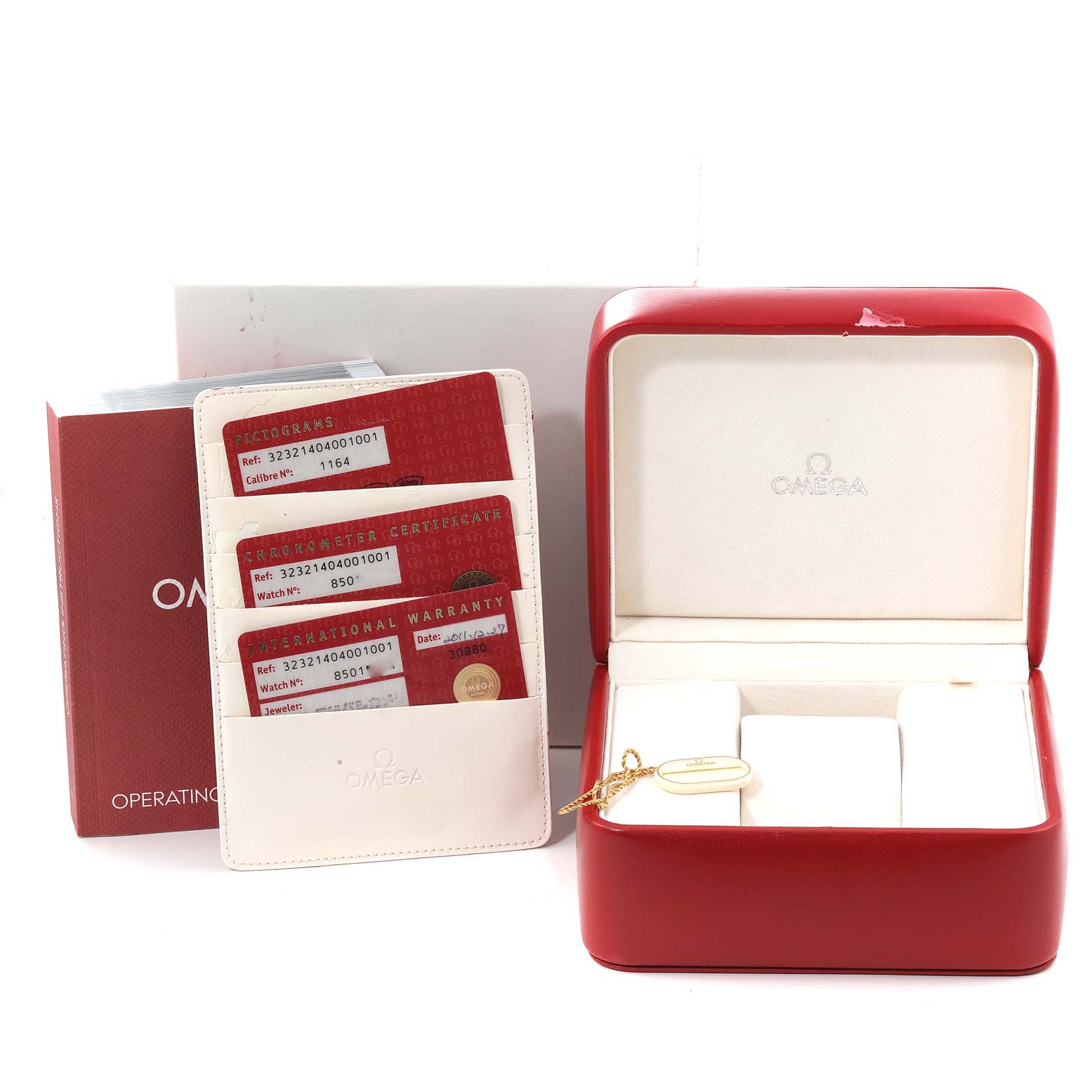 The image shows the packaging and certification cards for an Omega Speedmaster 323.21.40.40.01.001 Men's Steel and Gold (two tone) Black Dial 323.21.40.40.01.001 Men's Steel and Gold (two tone) Black Dial, including the red box and operating instructions.