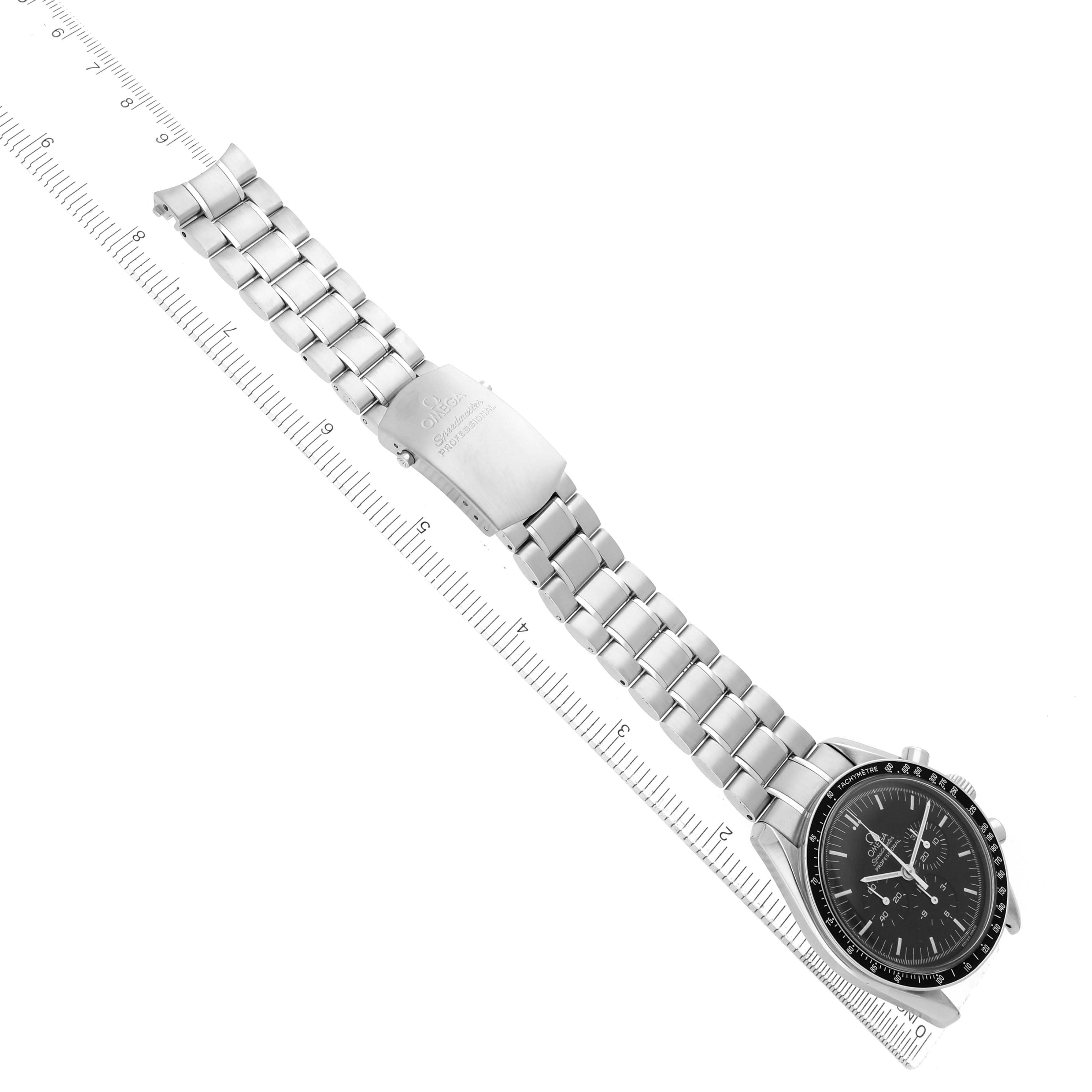 The Omega Speedmaster 3572.50.00 Men's Stainless Steel Black Dial watch is shown from a top angle, highlighting the full bracelet and clasp along a ruler.