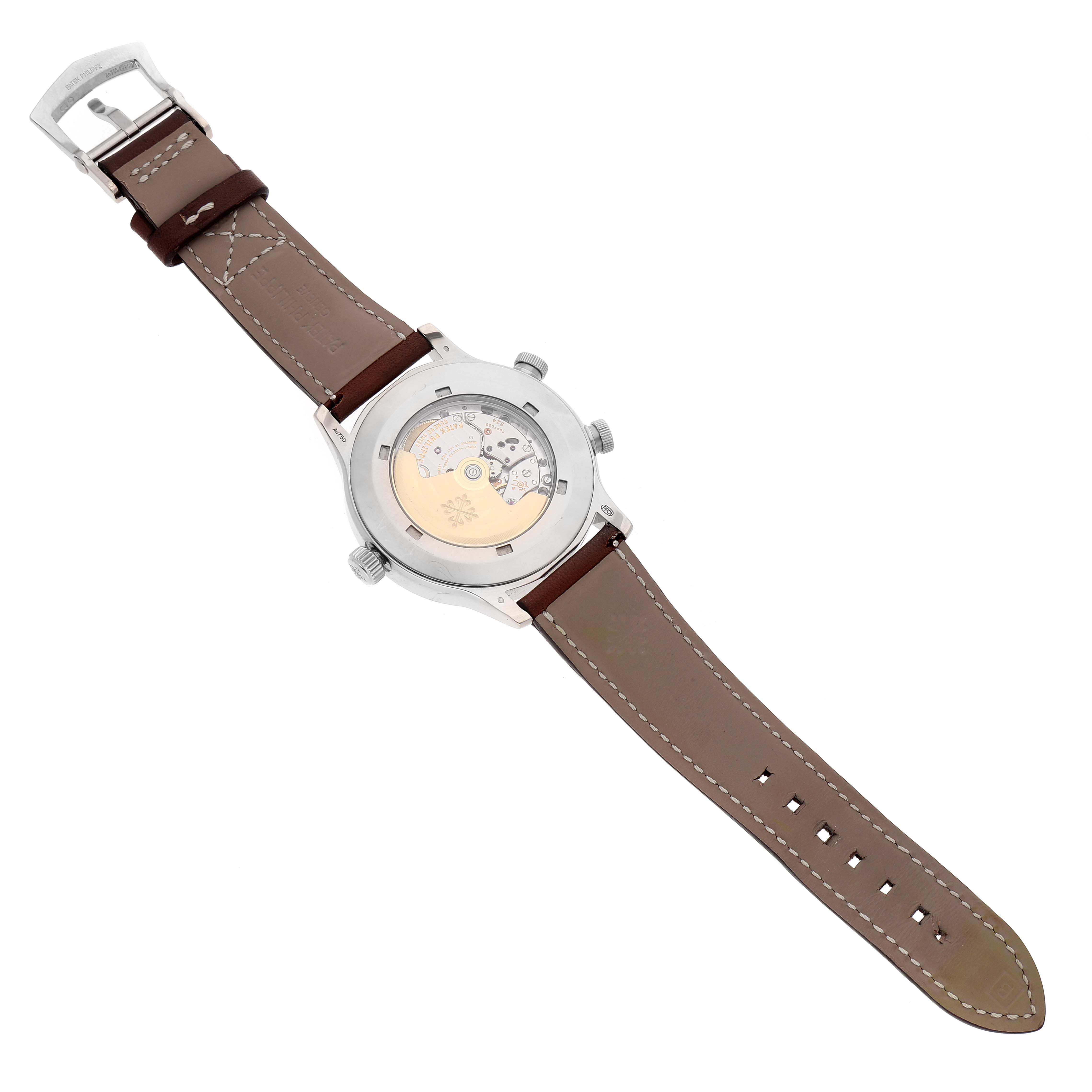 The image shows the back view of the Calatrava model by Patek Philippe, highlighting the watch's leather strap and exposed mechanical movement.