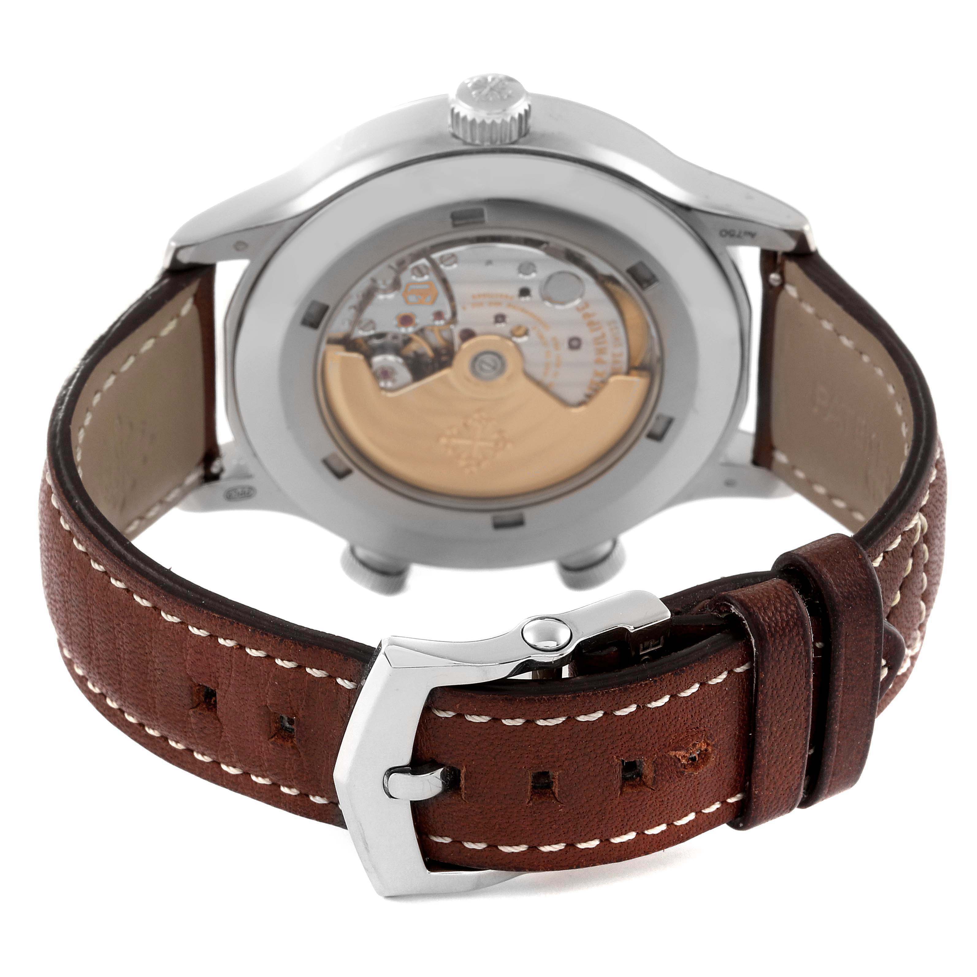This image shows the back and movement of the Patek Philippe Calatrava 5524G Men's White Gold Blue Dial 5524G Men's White Gold Blue Dial watch, along with its brown leather strap and buckle.