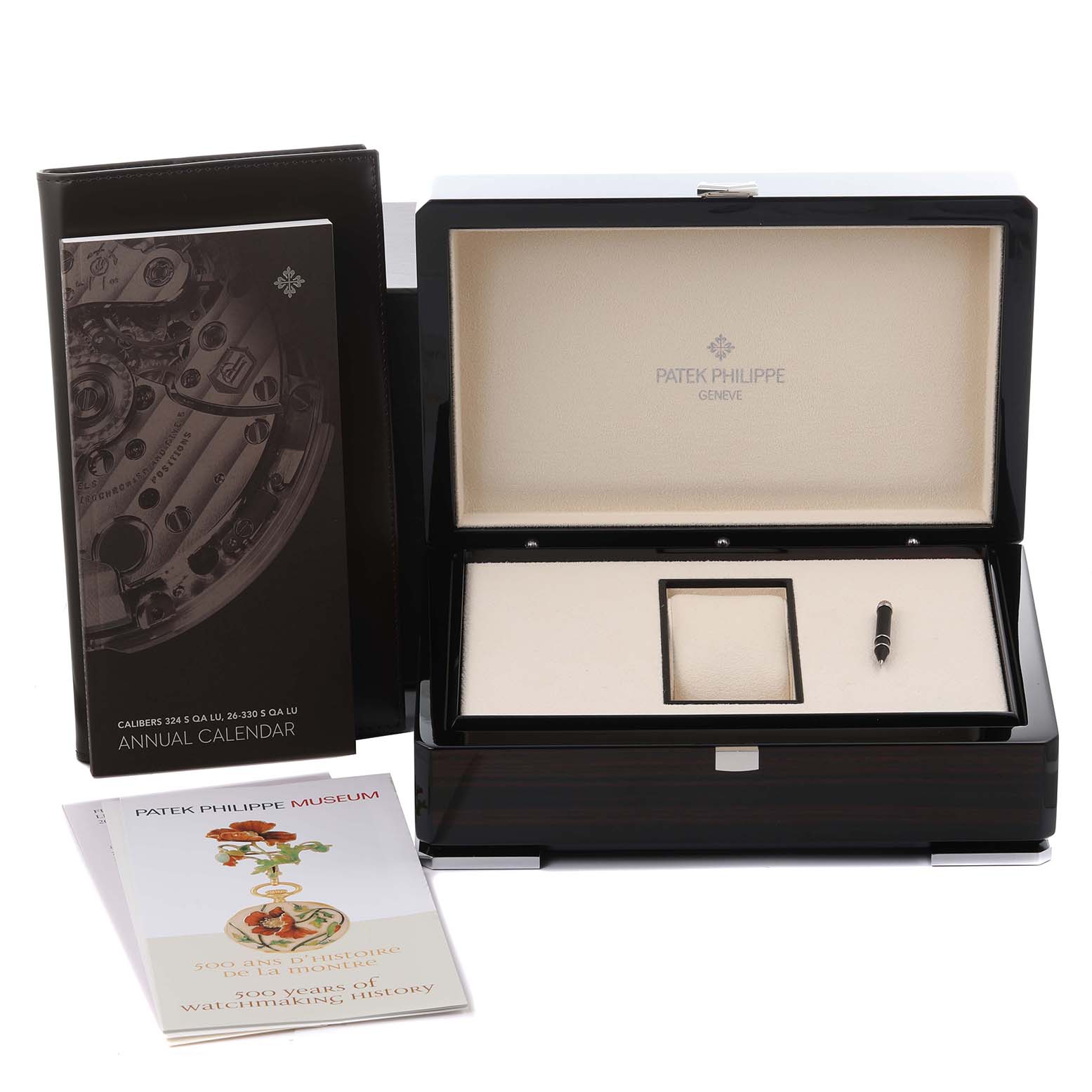 The image shows a Patek Philippe Complications 4947/1A-001 Men's Stainless Steel Blue Dial 4947/1A-001 Men's Stainless Steel Blue Dial watch box with manuals and a tool pen.