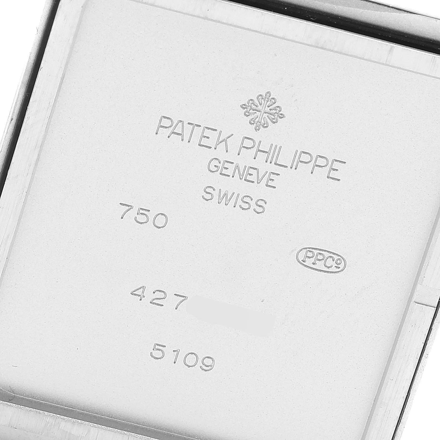 The image shows the back casing of a Patek Philippe Gondolo 5109 Men's White Gold Silver Dial 5109 Men's White Gold Silver Dial watch, displaying brand engravings and serial numbers.
