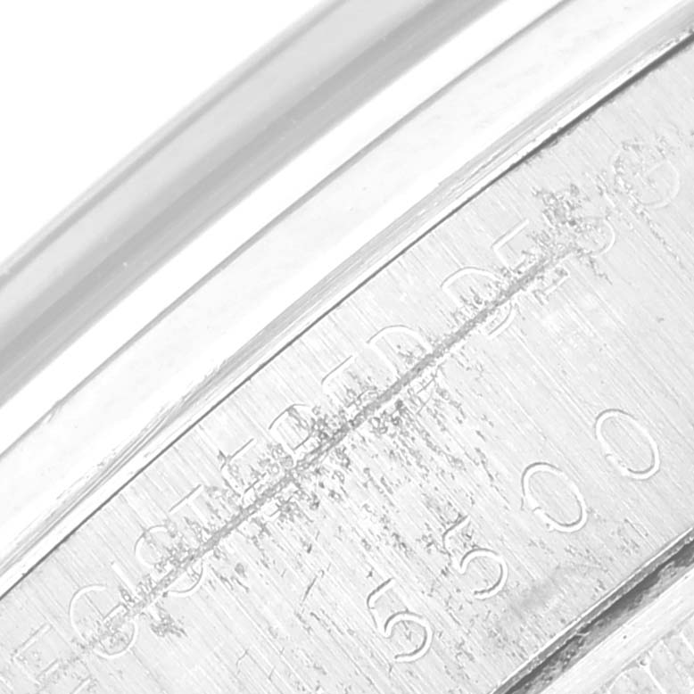 This image shows a close-up of the case back edge of a Vintage Collection Rolex watch, highlighting the serial number engraving.