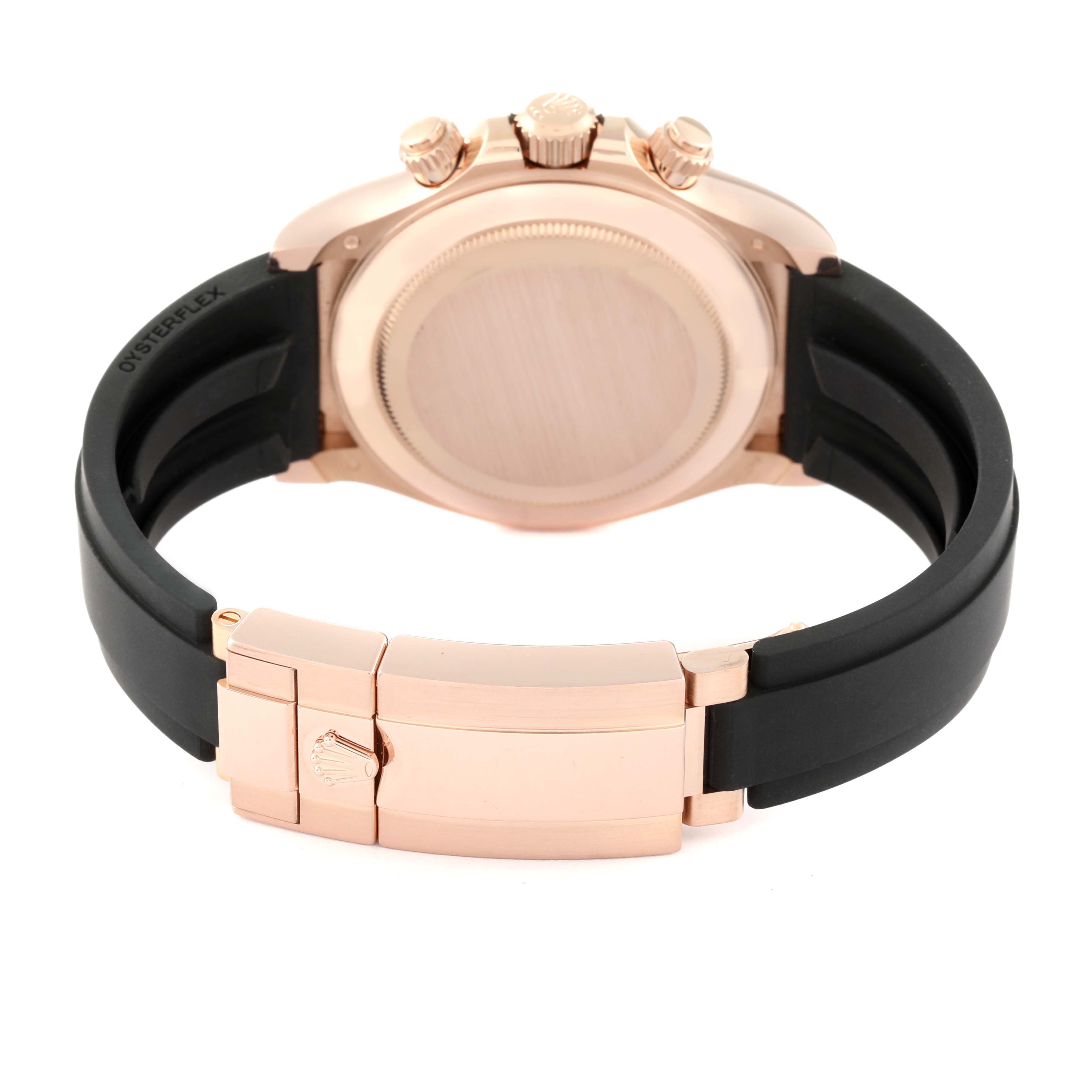 The image shows the back of a Rolex Daytona 116515LN Men's Rose Gold Champagne Dial 116515LN Men's Rose Gold Champagne Dial watch with its clasp and crown, featuring a black strap.