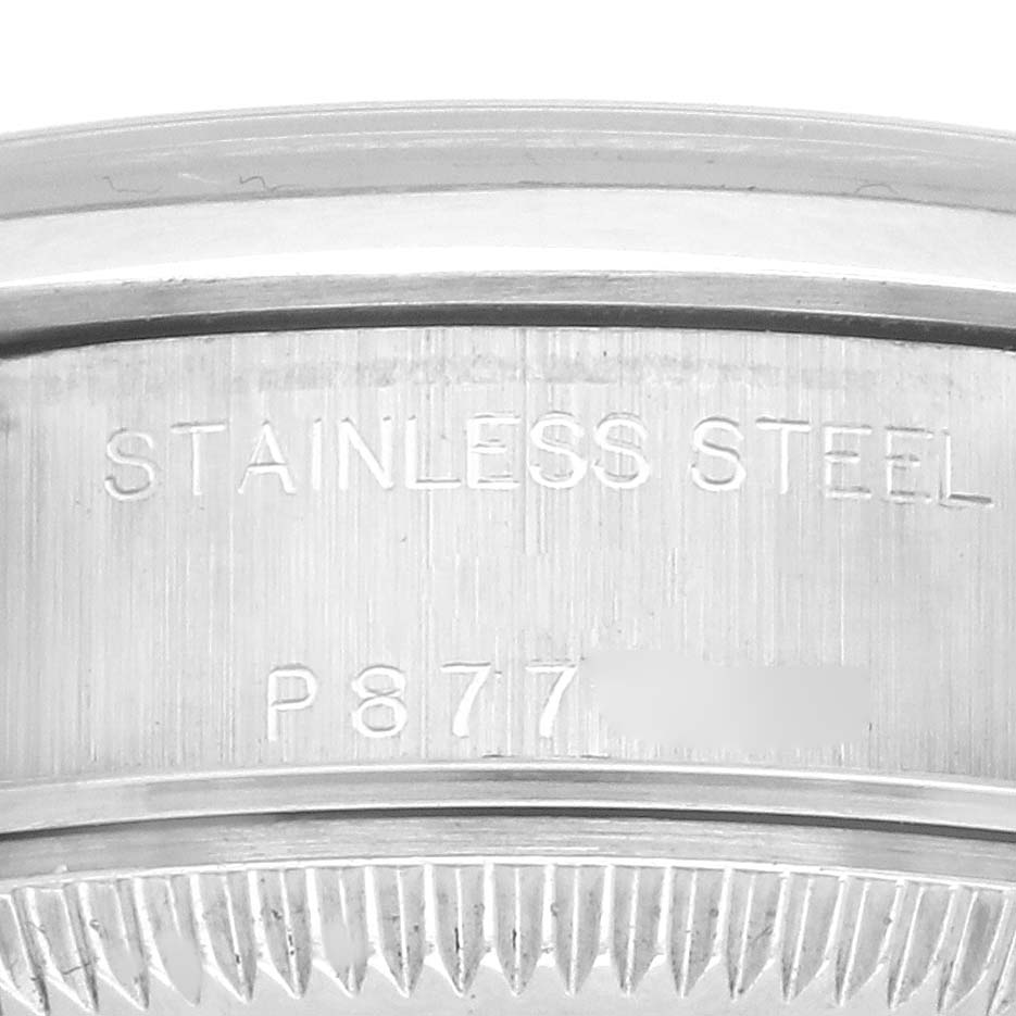 The image shows the engraved steel case back of a Rolex Date 79160 Women's Stainless Steel Black Dial 79160 Women's Stainless Steel Black Dial model watch, focusing on the "STAINLESS STEEL" inscription.